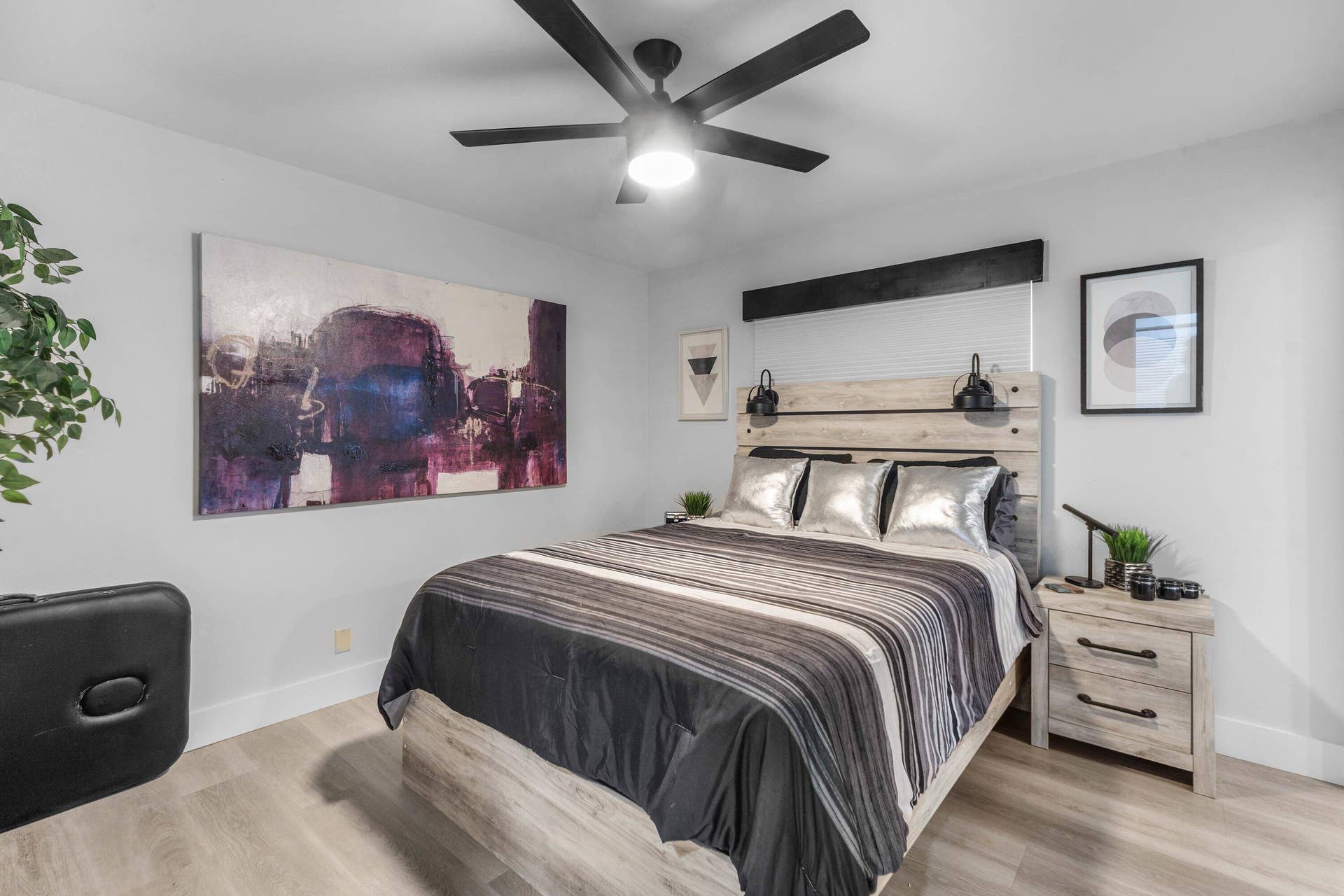 13138 Touchstone Place, Palm Beach Gardens, FL 33418 Integrated ceiling fan, light wood-finish flooring, light gray wall tones, built-in wall sconces, and a light wood-finish headboard