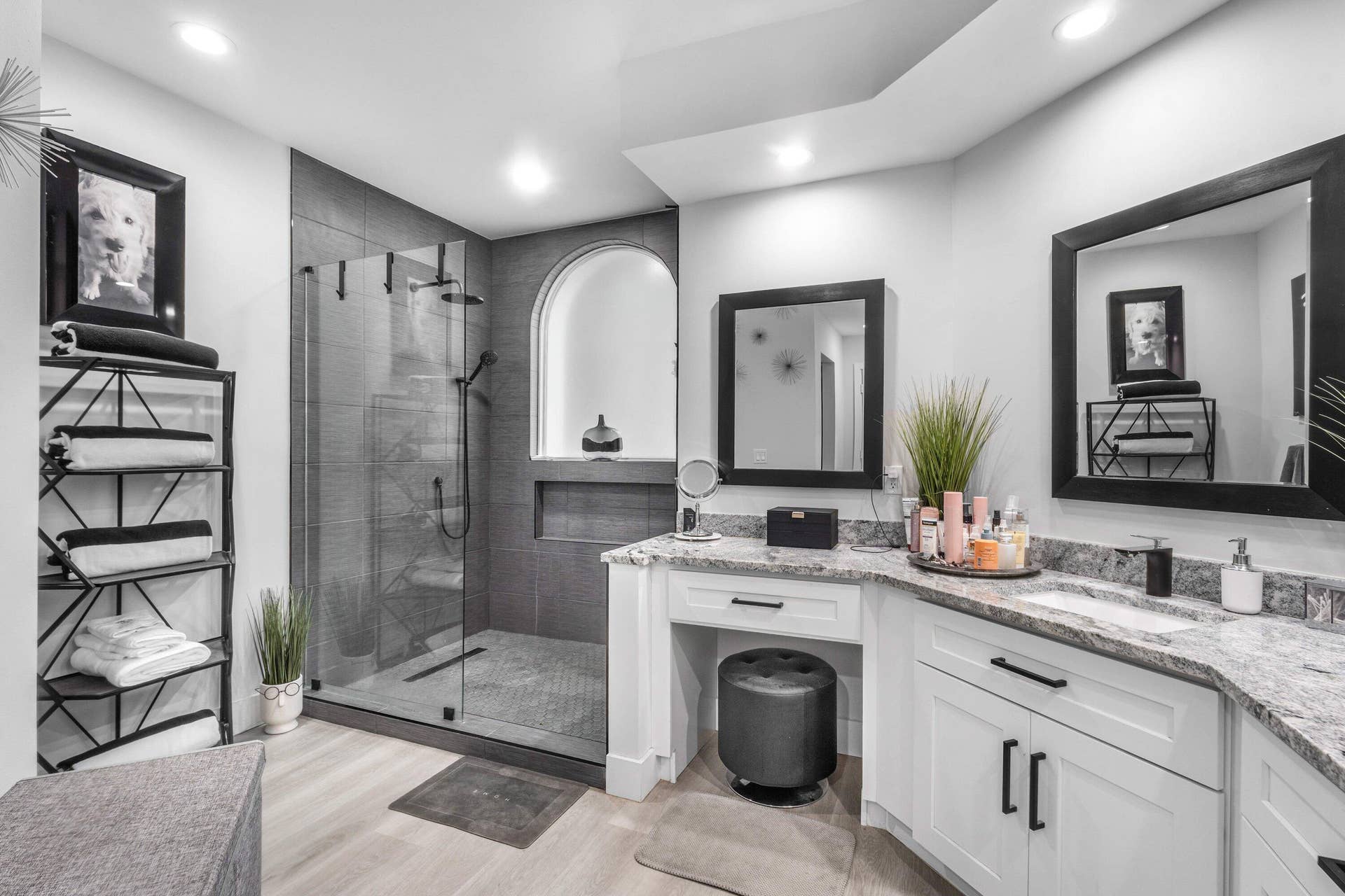 13138 Touchstone Place, Palm Beach Gardens, FL 33418 Walk-in shower with dark tile surround, glass enclosure, and arched niche