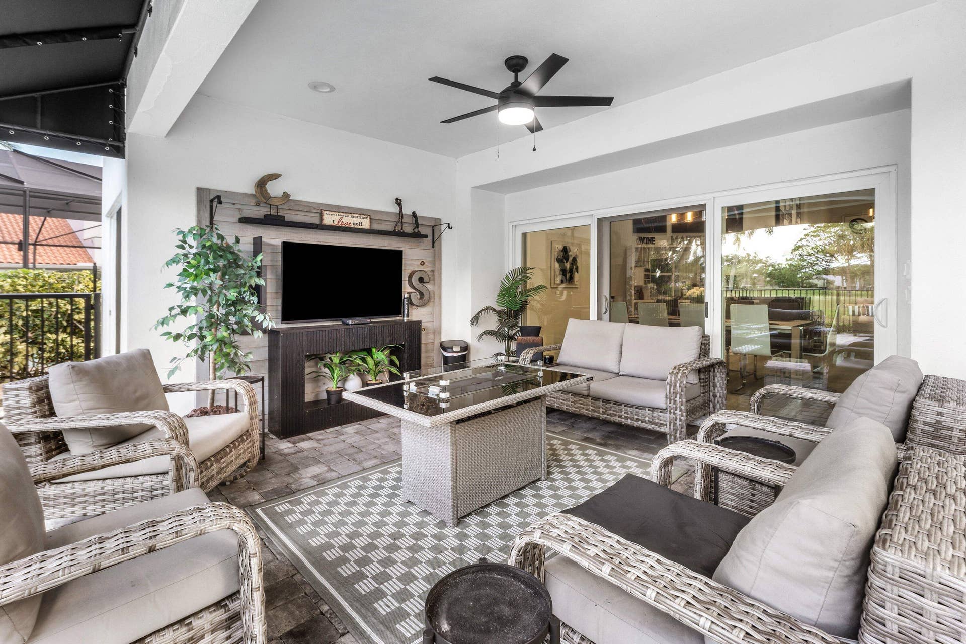 13138 Touchstone Place, Palm Beach Gardens, FL 33418 Covered patio featuring paver flooring, a ceiling fan, and sliding glass doors