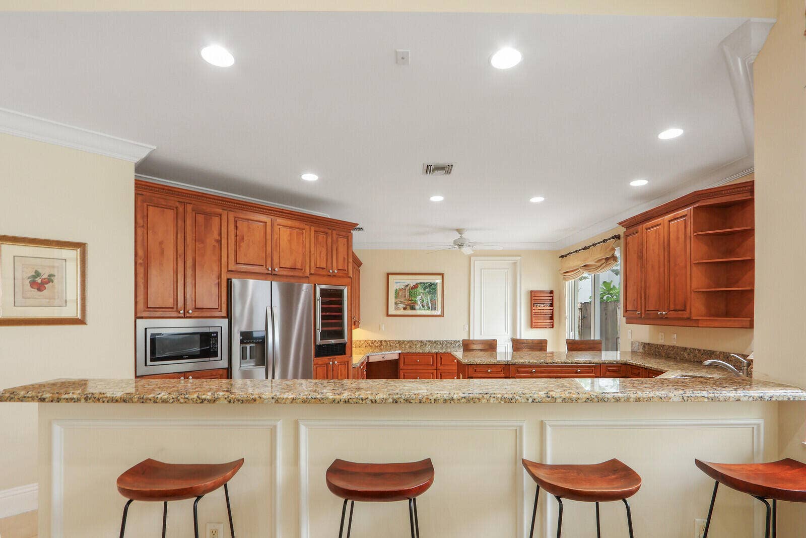 Kitchen featuring wood cabinetry, stainless steel appliances, and stone countertops