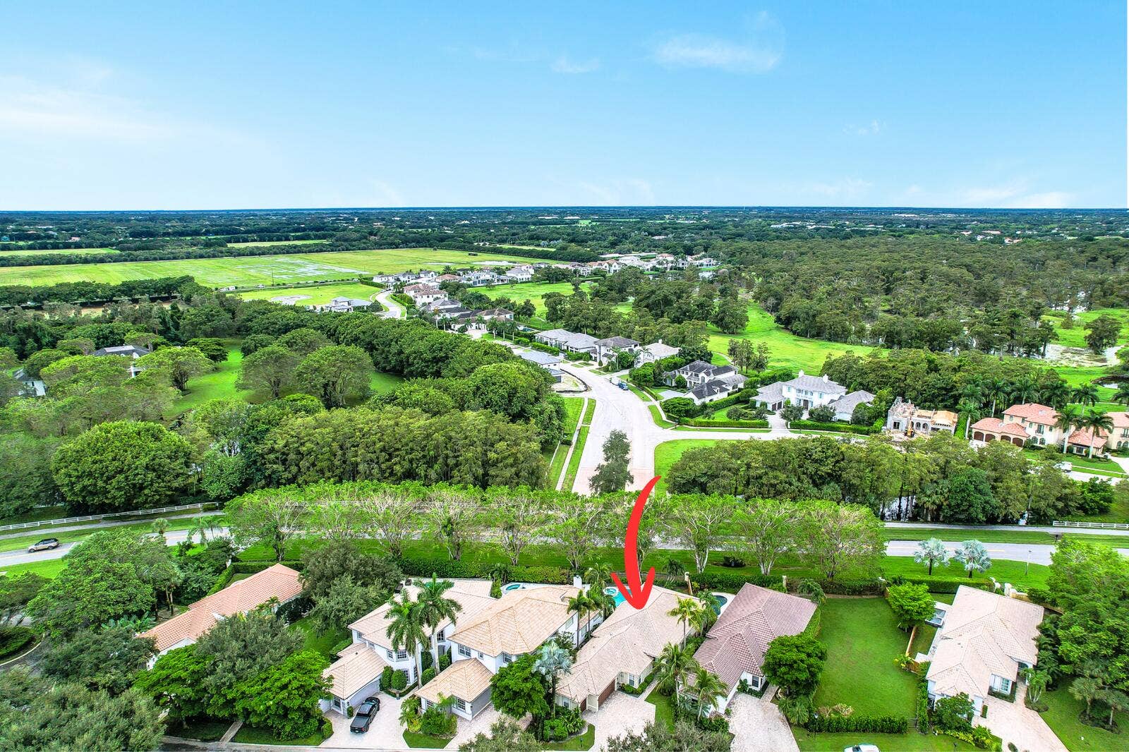 Aerial perspective showcasing residential properties and surrounding green spaces
