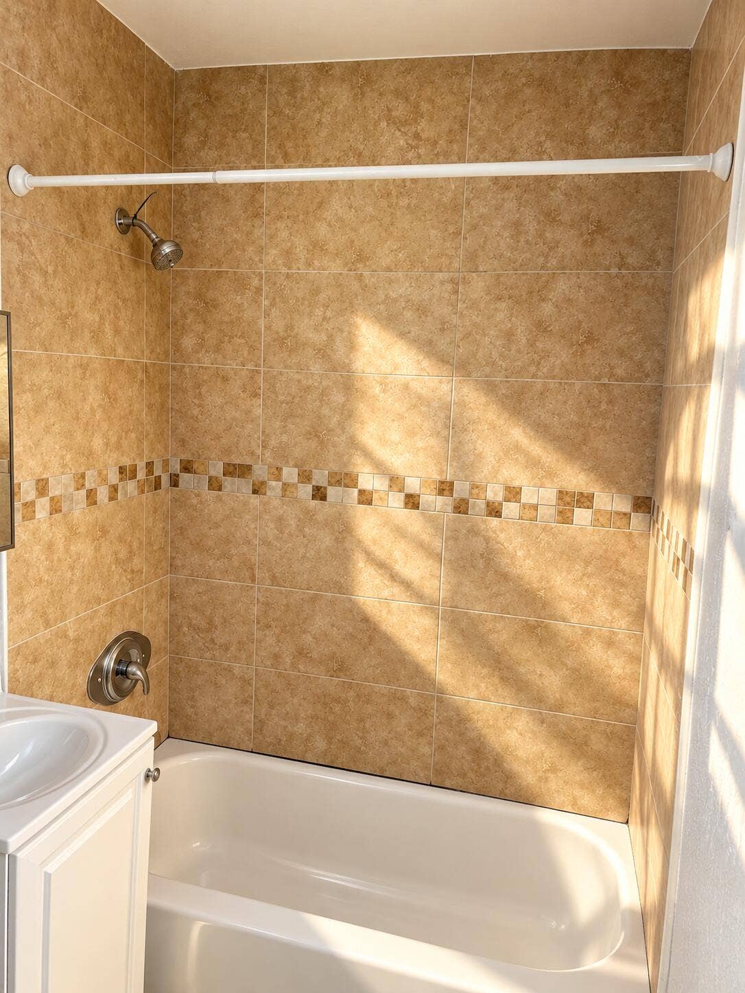 Sunlit Warm-Toned Tiled Bathtub Alcove