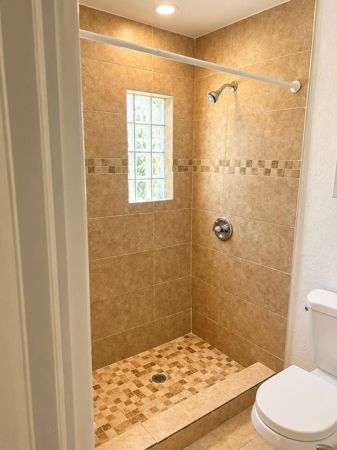 Warmly Lit Beige Tile Shower
