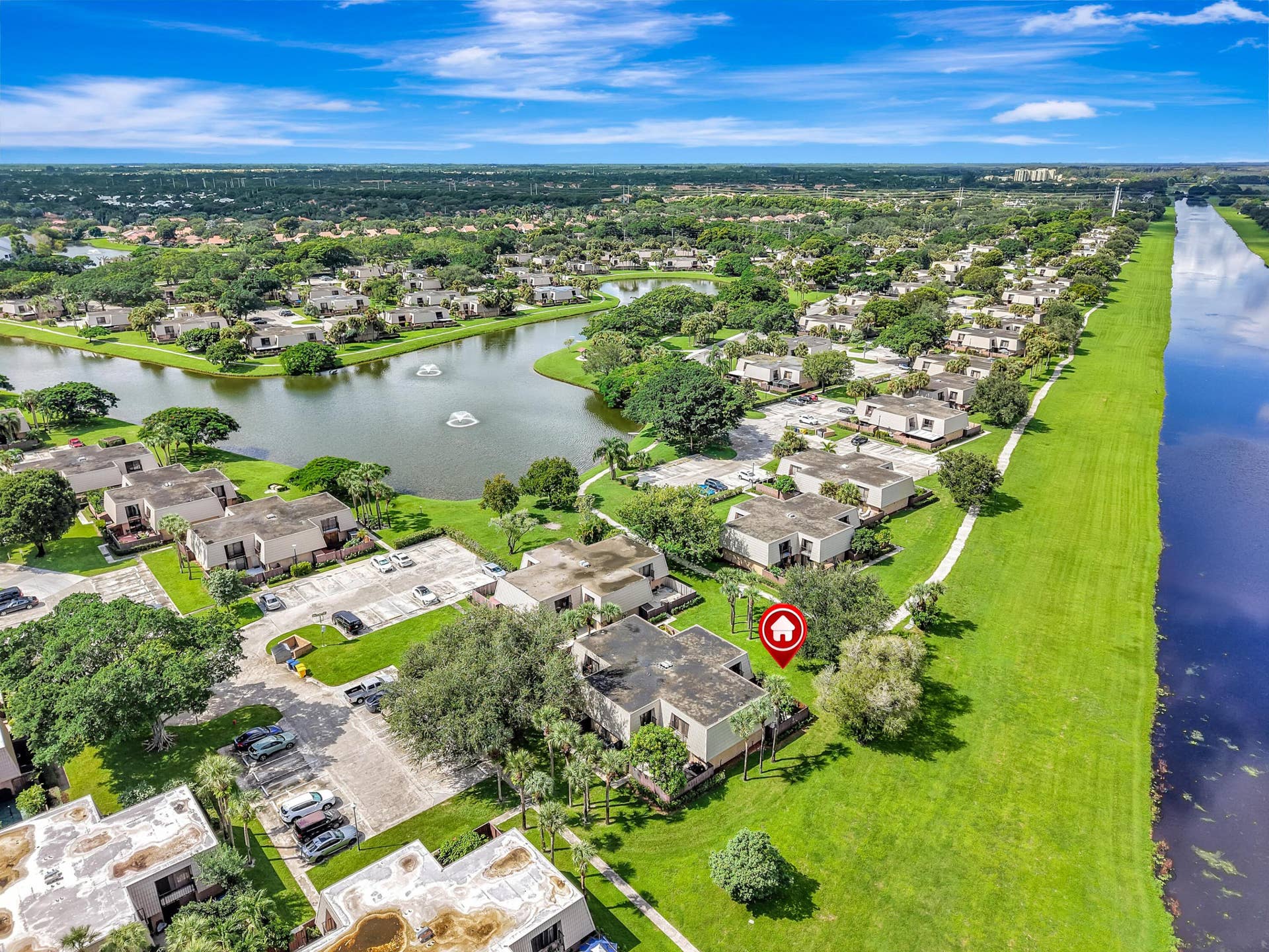 Aerial location of townhome facing water and mature treelined courtyard
