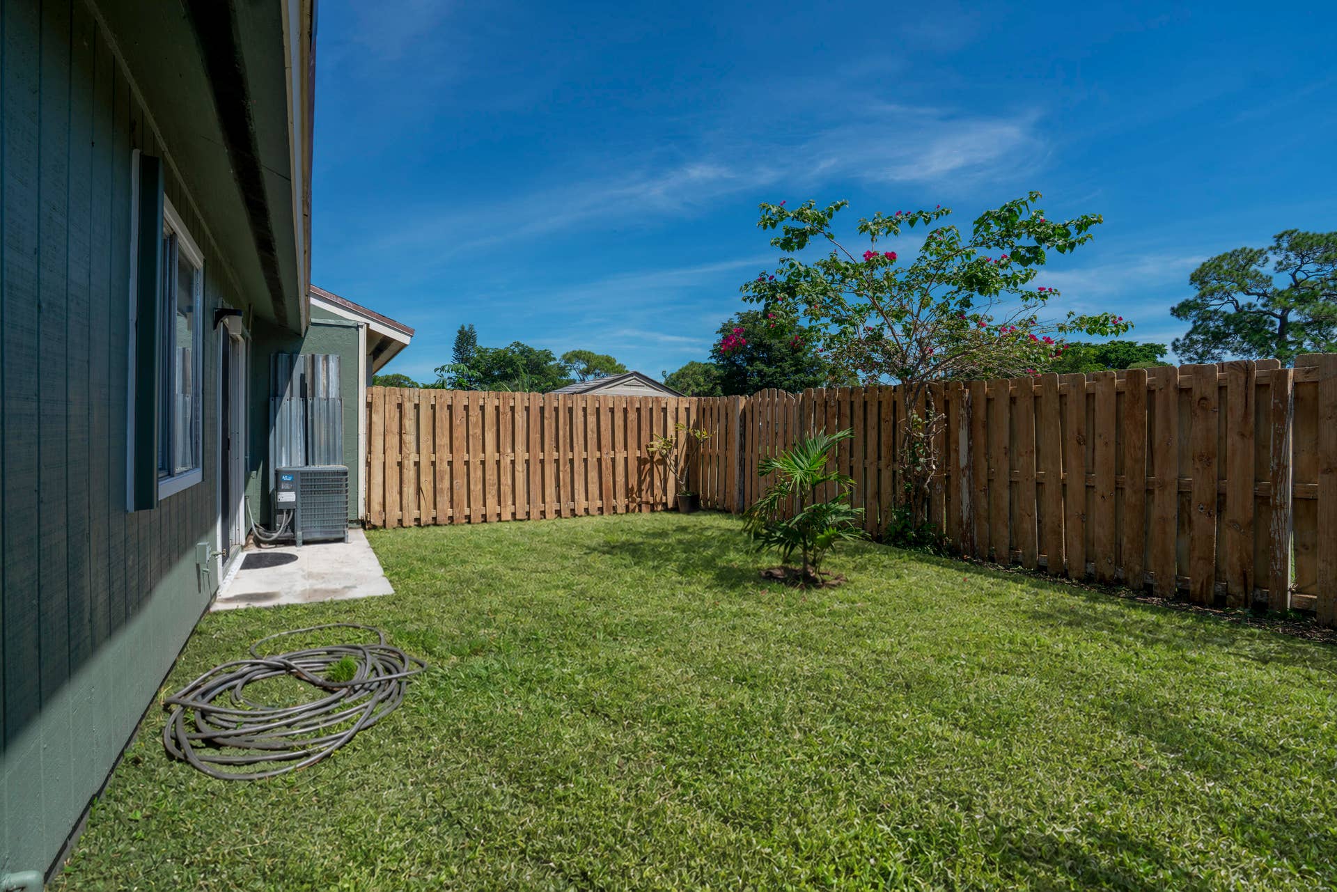 Private backyard with wood plank fencing and a concrete patio