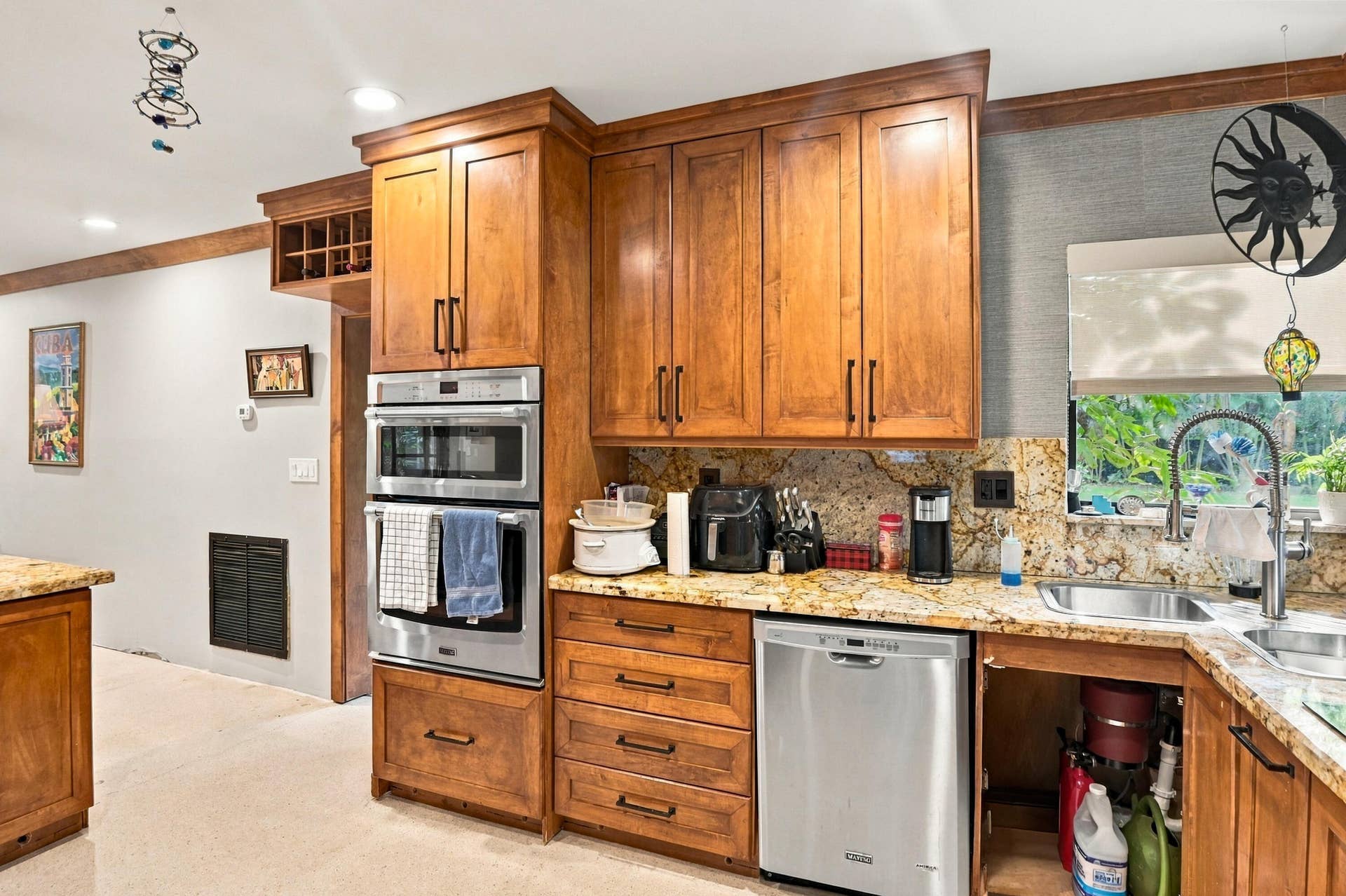 1549 SW 30th Place, Fort Lauderdale, FL 33315 Wood cabinetry with a built-in wine rack, stone countertops, and stainless steel appliances