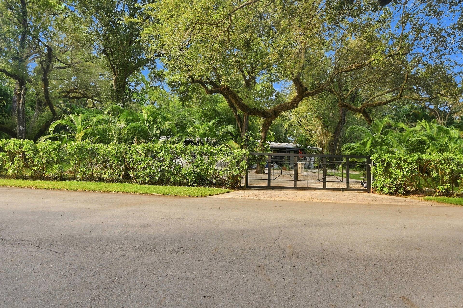 1549 SW 30th Place, Fort Lauderdale, FL 33315 Gated entry with lush perimeter landscaping and mature trees