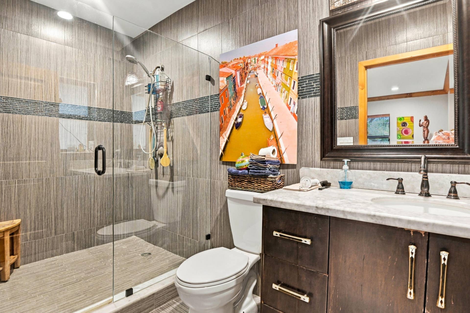 1549 SW 30th Place, Fort Lauderdale, FL 33315 Glass-enclosed shower with a rainfall showerhead, full wall tiling, and a mosaic tile accent band