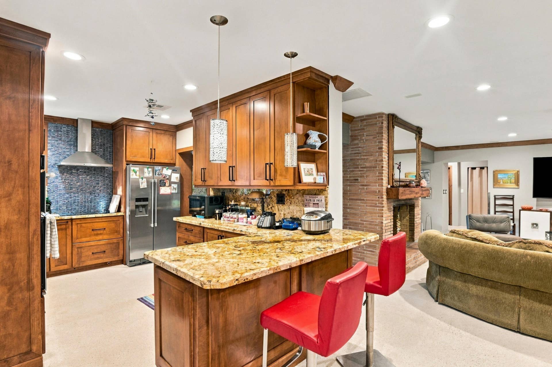 1549 SW 30th Place, Fort Lauderdale, FL 33315 Kitchen featuring wood cabinetry, granite countertops, and a tiled backsplash