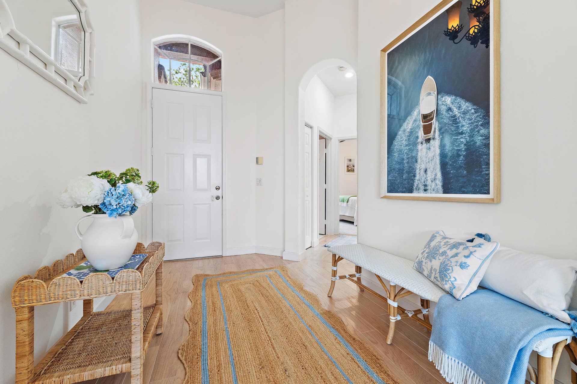Bright, welcoming foyer with soaring ceilings and a fresh coastal feel