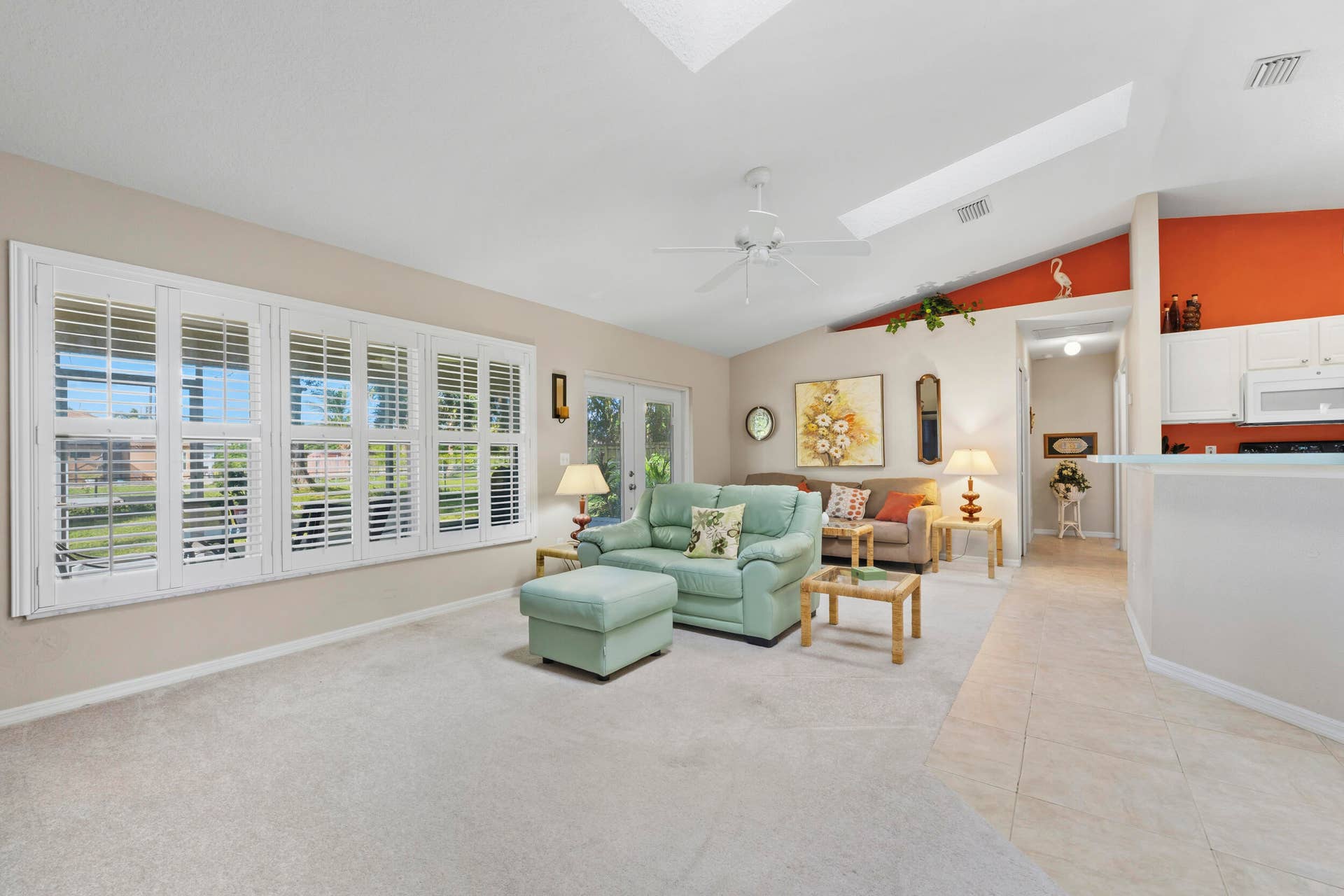 1649 SW ALVATON Avenue, Port St Lucie, FL 34953 Vaulted ceilings with integrated skylights, plantation shutters, ceiling fan, and ceramic tile flooring