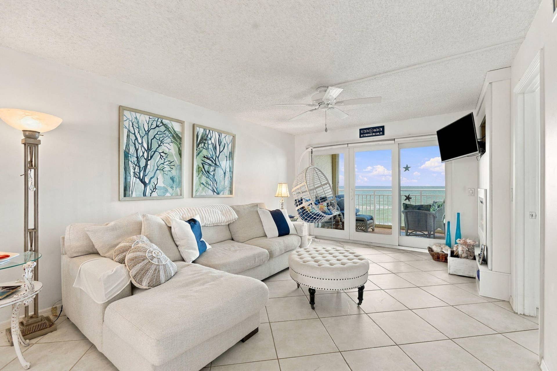Living area featuring a ceiling fan, tiled flooring, and sliding glass doors to the exterior