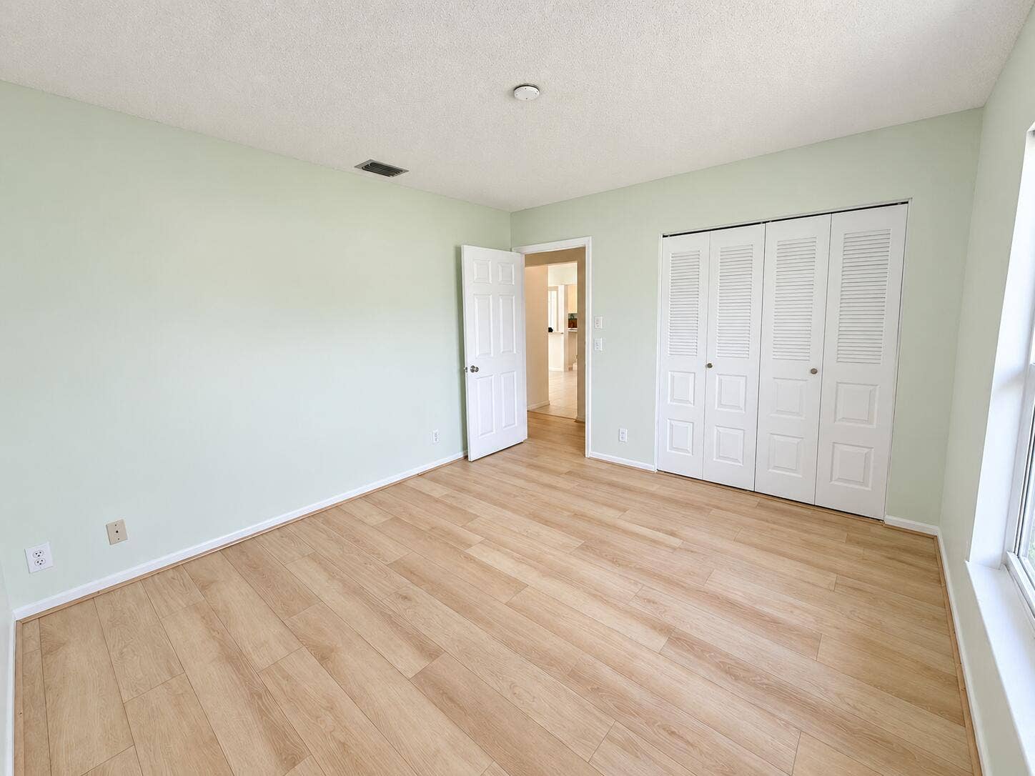 Brightened mint bedroom, clutter removed