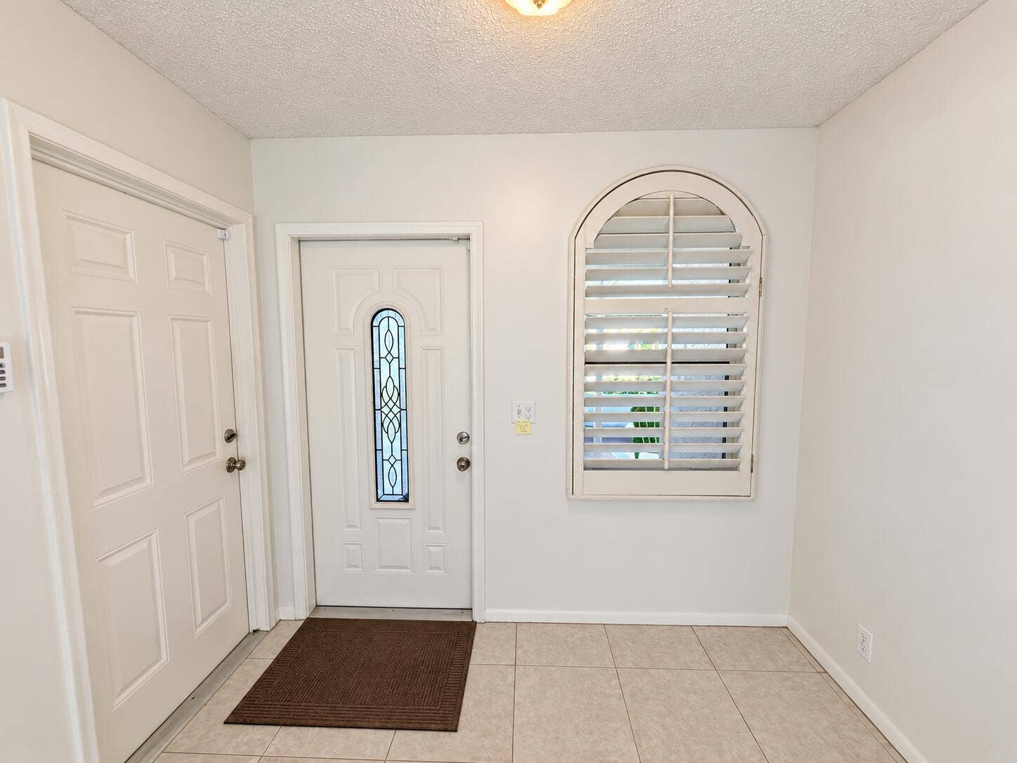 Brightened front entry, faithfully prese