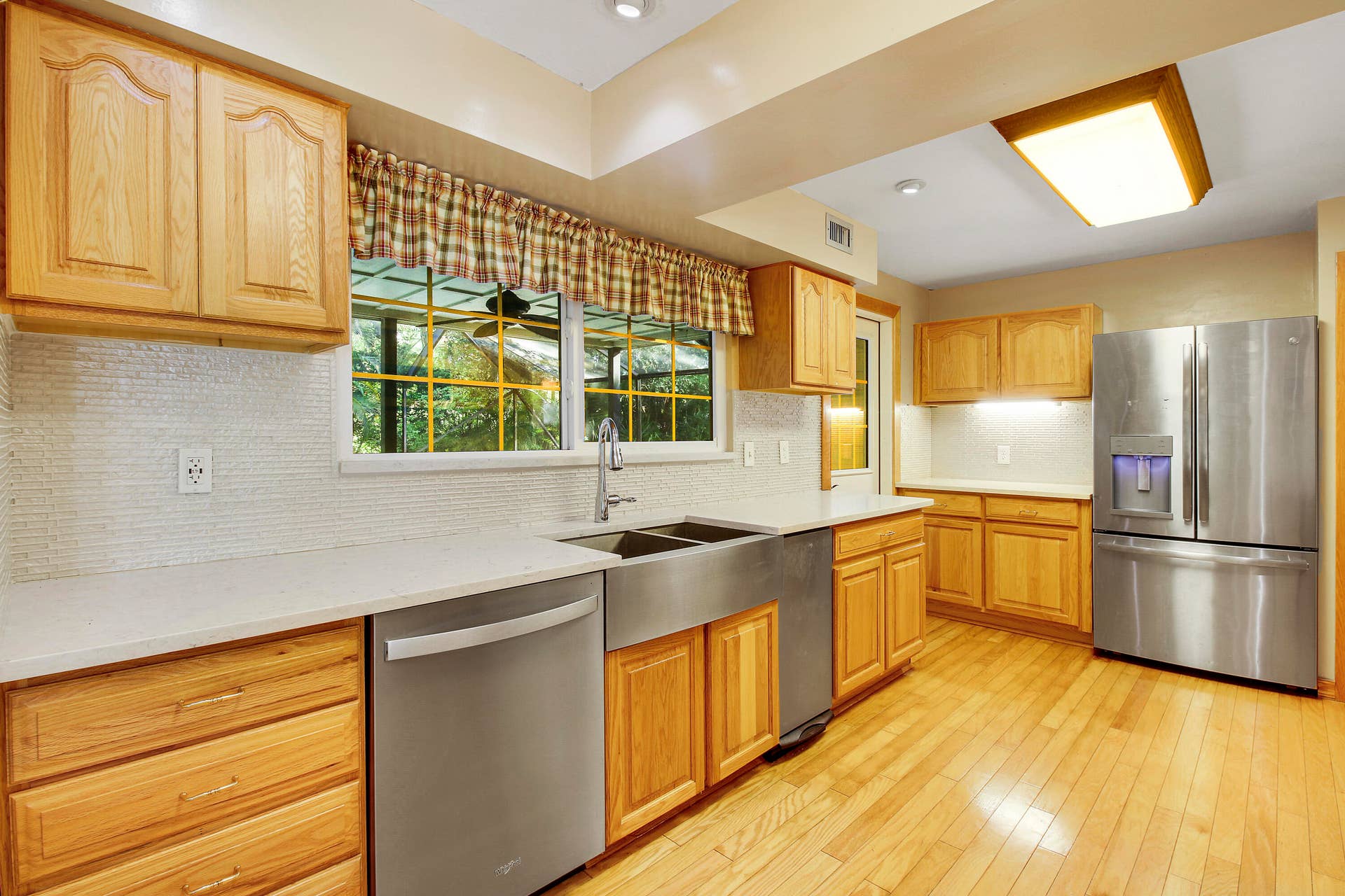 5673 OLD ORANGE Road, Jupiter, FL 33458 Farm House sink with view to the pool and Chickee