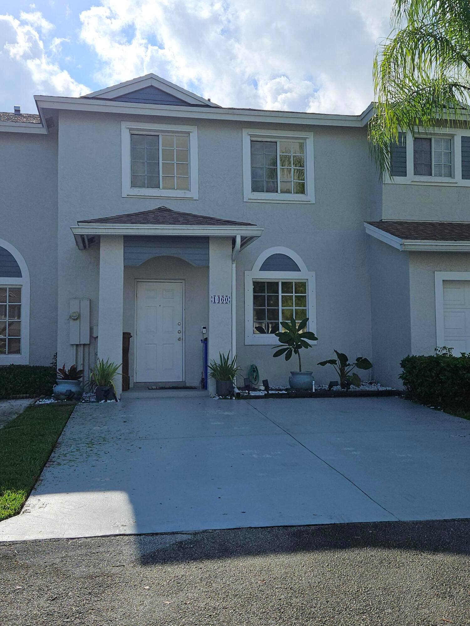 1460 SW 47TH Avenue, #1460, Deerfield Beach, Deerfield Beach, FL 33442 Two-story stucco exterior with white-framed windows, a covered entry, and a paved driveway