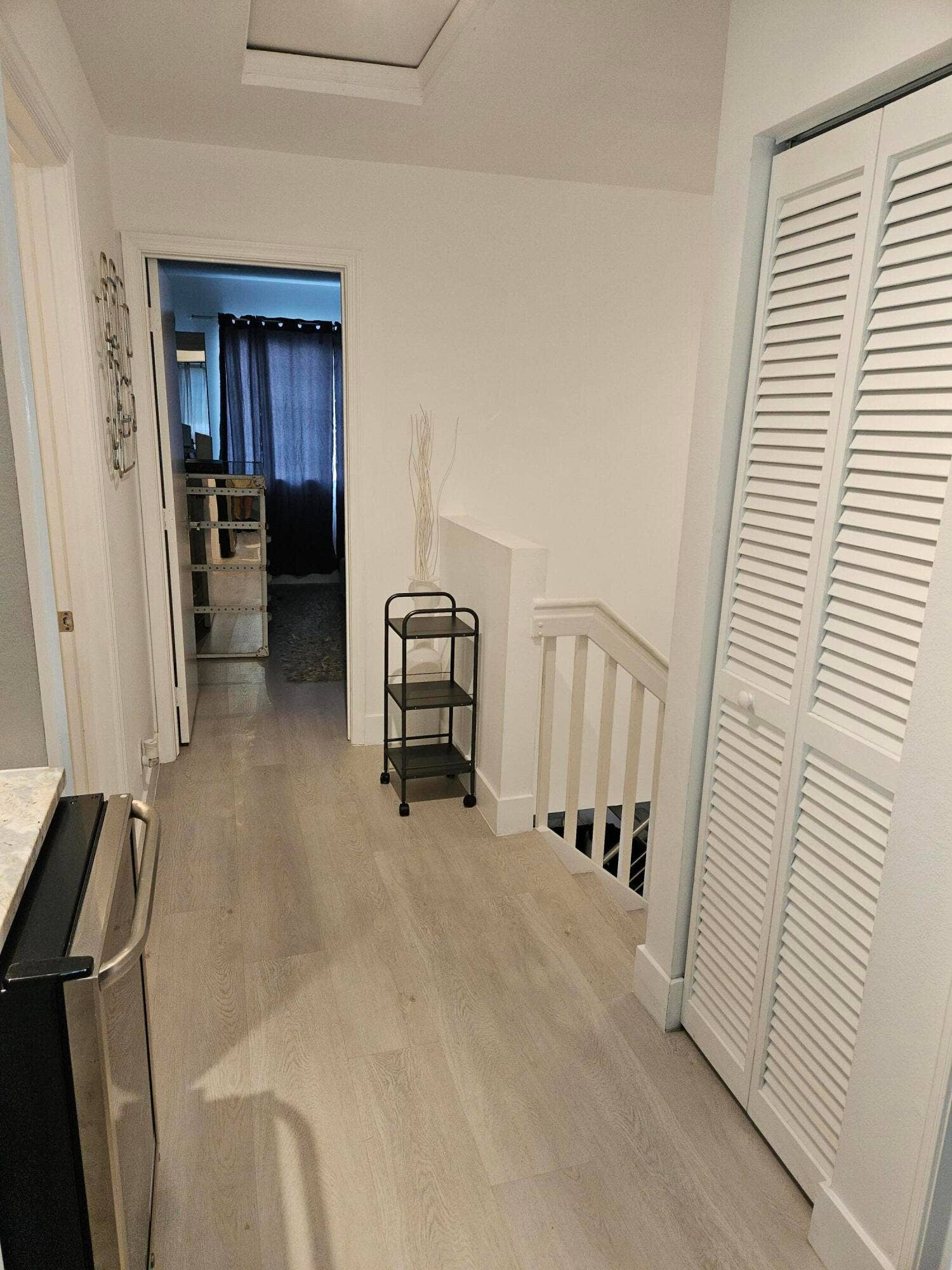 1460 SW 47TH Avenue, #1460, Deerfield Beach, Deerfield Beach, FL 33442 Recessed ceiling access panel, wood-finish flooring, white painted walls, white louvered closet doors, and white painted stair railing