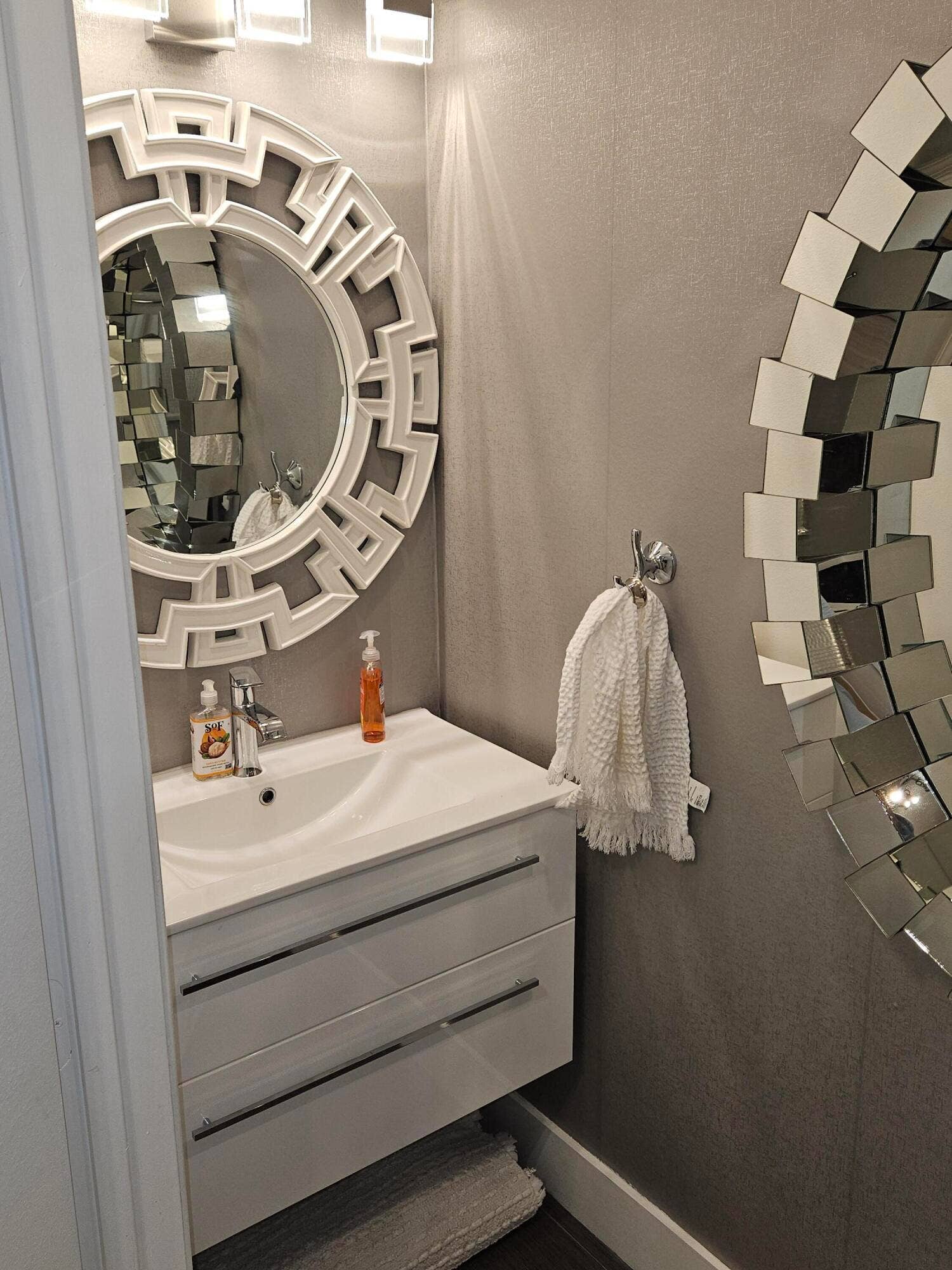 1460 SW 47TH Avenue, #1460, Deerfield Beach, Deerfield Beach, FL 33442 Wall-mounted vanity with integrated basin, polished chrome faucet, and decorative wall mirror