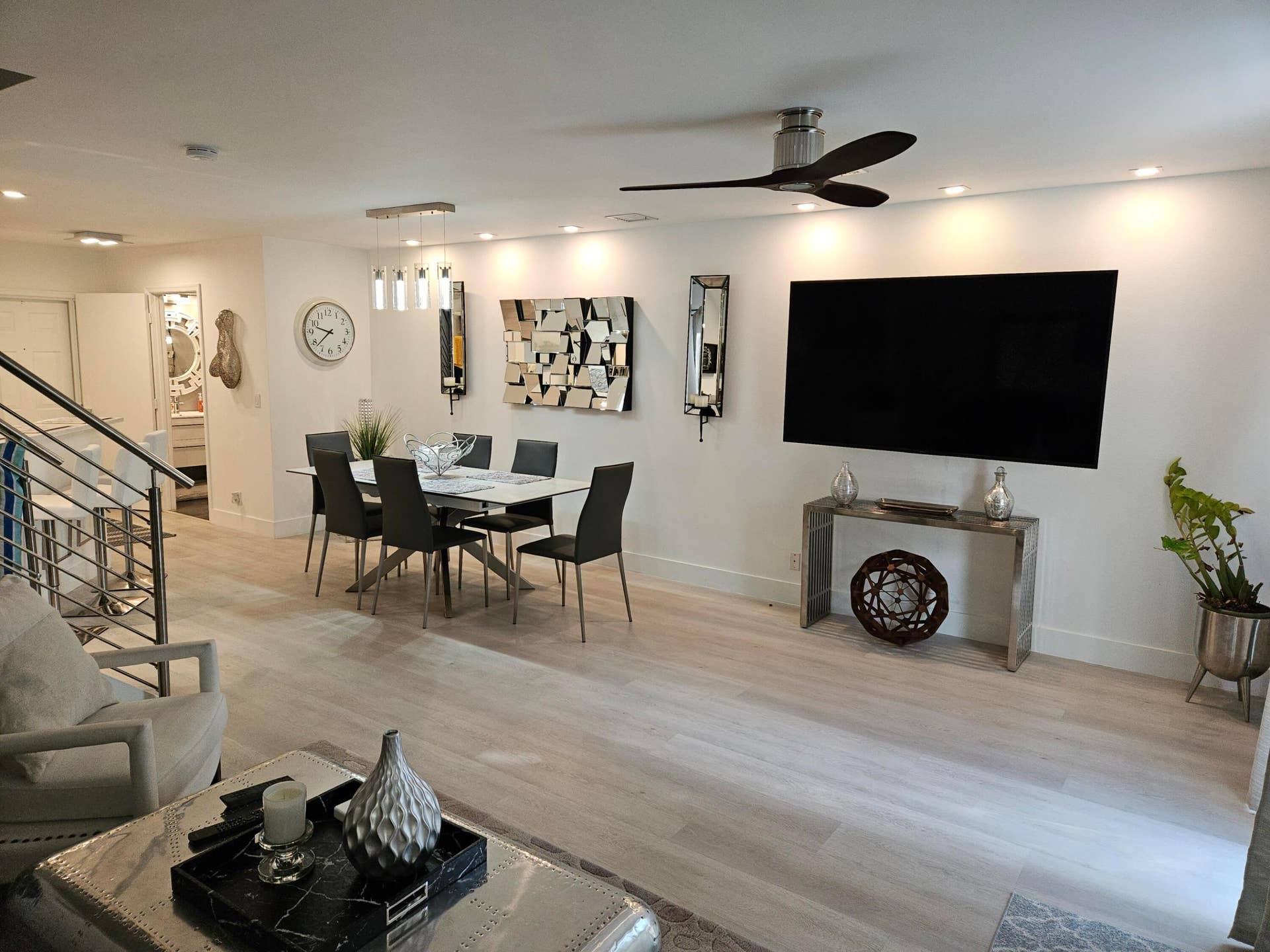 1460 SW 47TH Avenue, #1460, Deerfield Beach, Deerfield Beach, FL 33442 Wood-finish flooring, recessed lighting, modern ceiling fan, stainless steel staircase railing, and contemporary dining light fixture