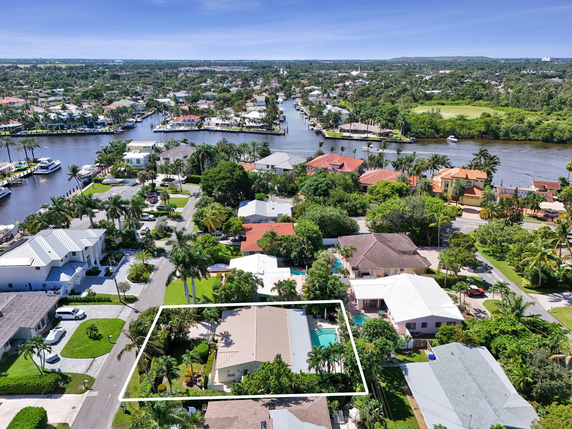 Property featuring a private swimming pool, mature tropical landscaping, and a tile roof