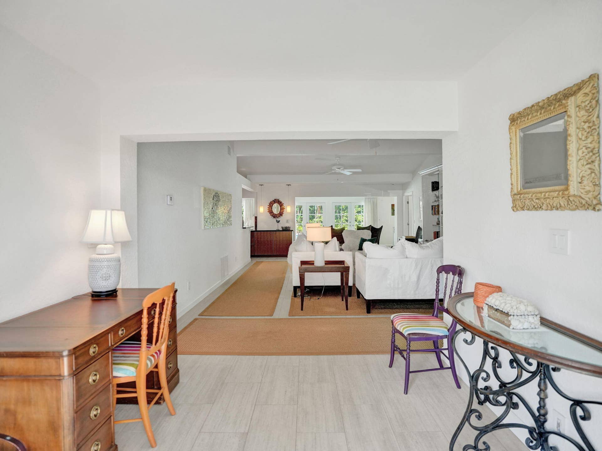 Light tile flooring extending into an open-concept living area.