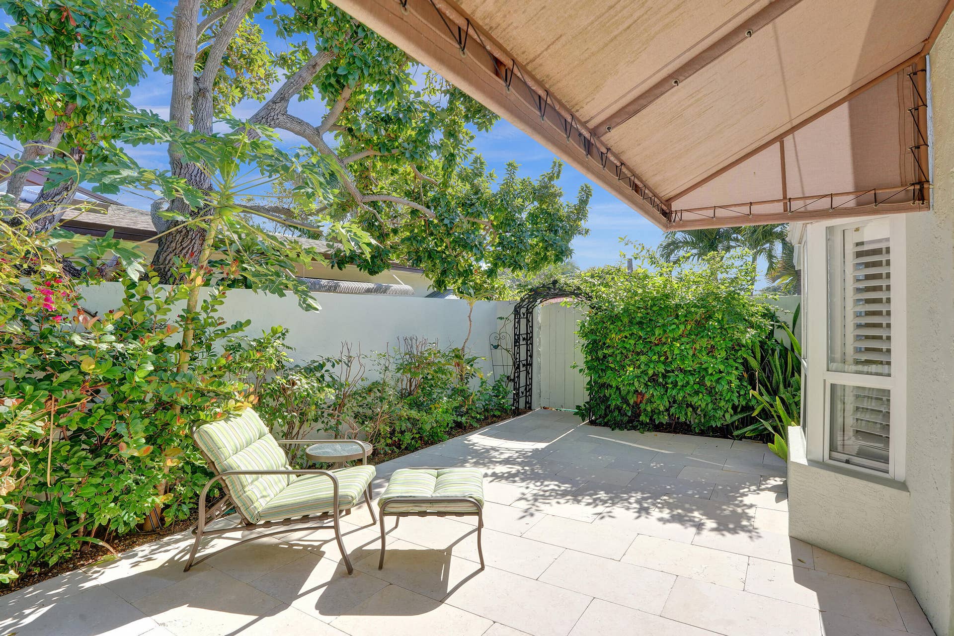 Double-doors lead to a private patio retreat.
