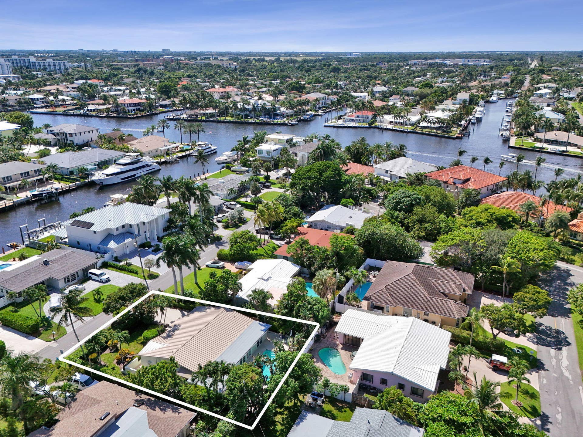 Expansive property featuring a private swimming pool, mature landscaping, and an attached garage