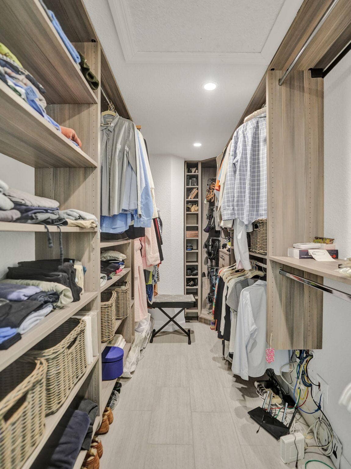 Custom closet organization system with wood-finish shelving and integrated hanging rods