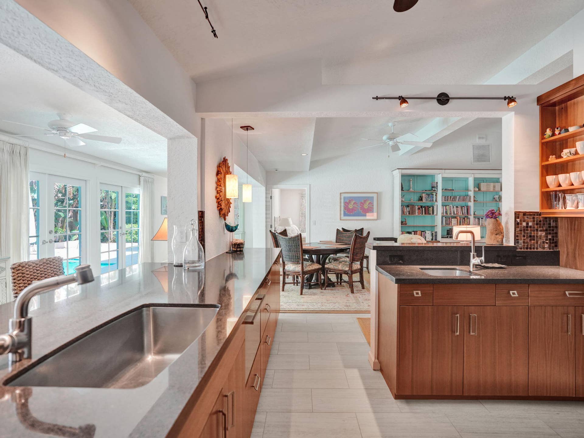 Kitchen featuring a stainless steel sink, wood-finish cabinetry, and dark countertops