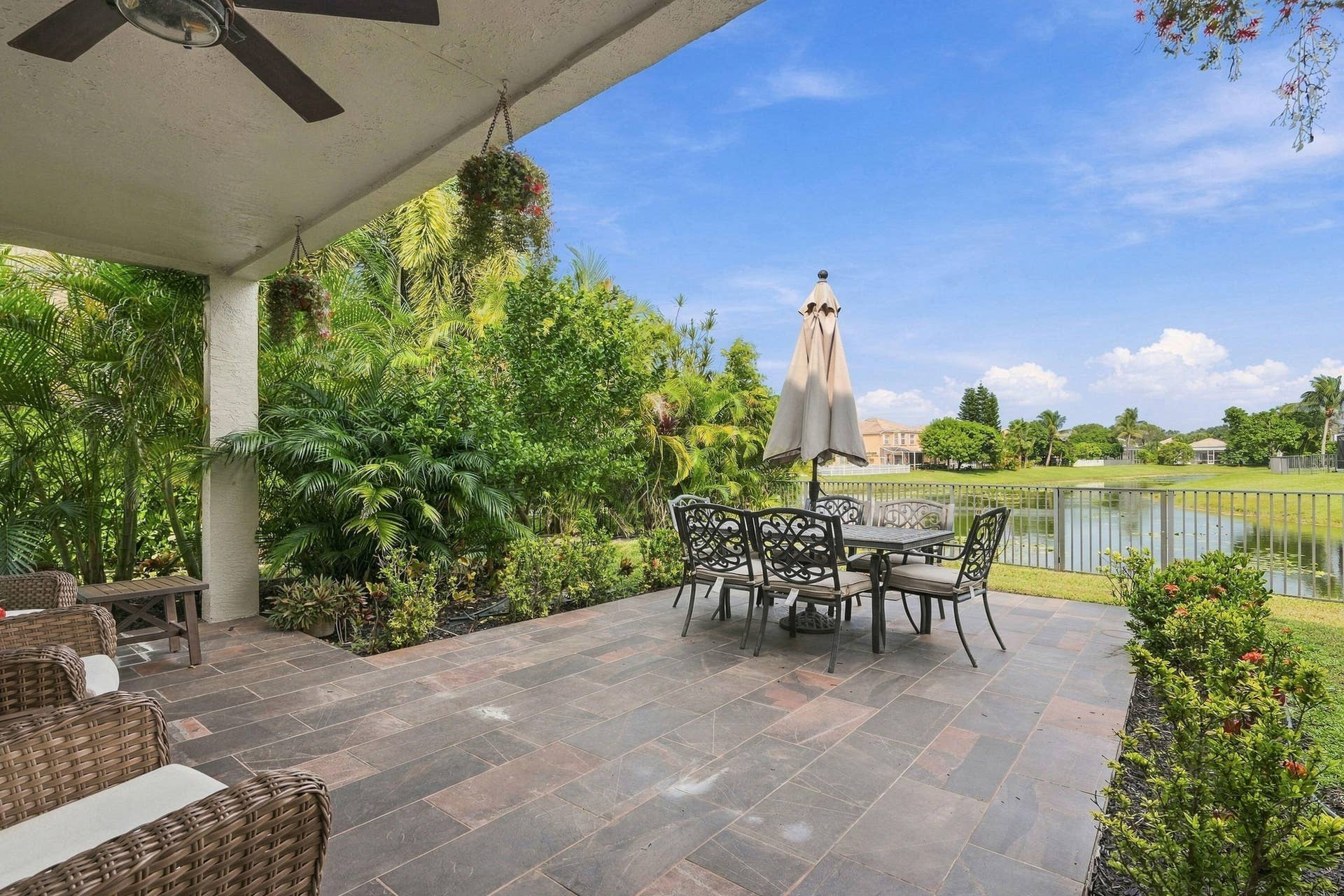 Outdoor covered patio with beautiful stone finishes and gorgeous wide water view.