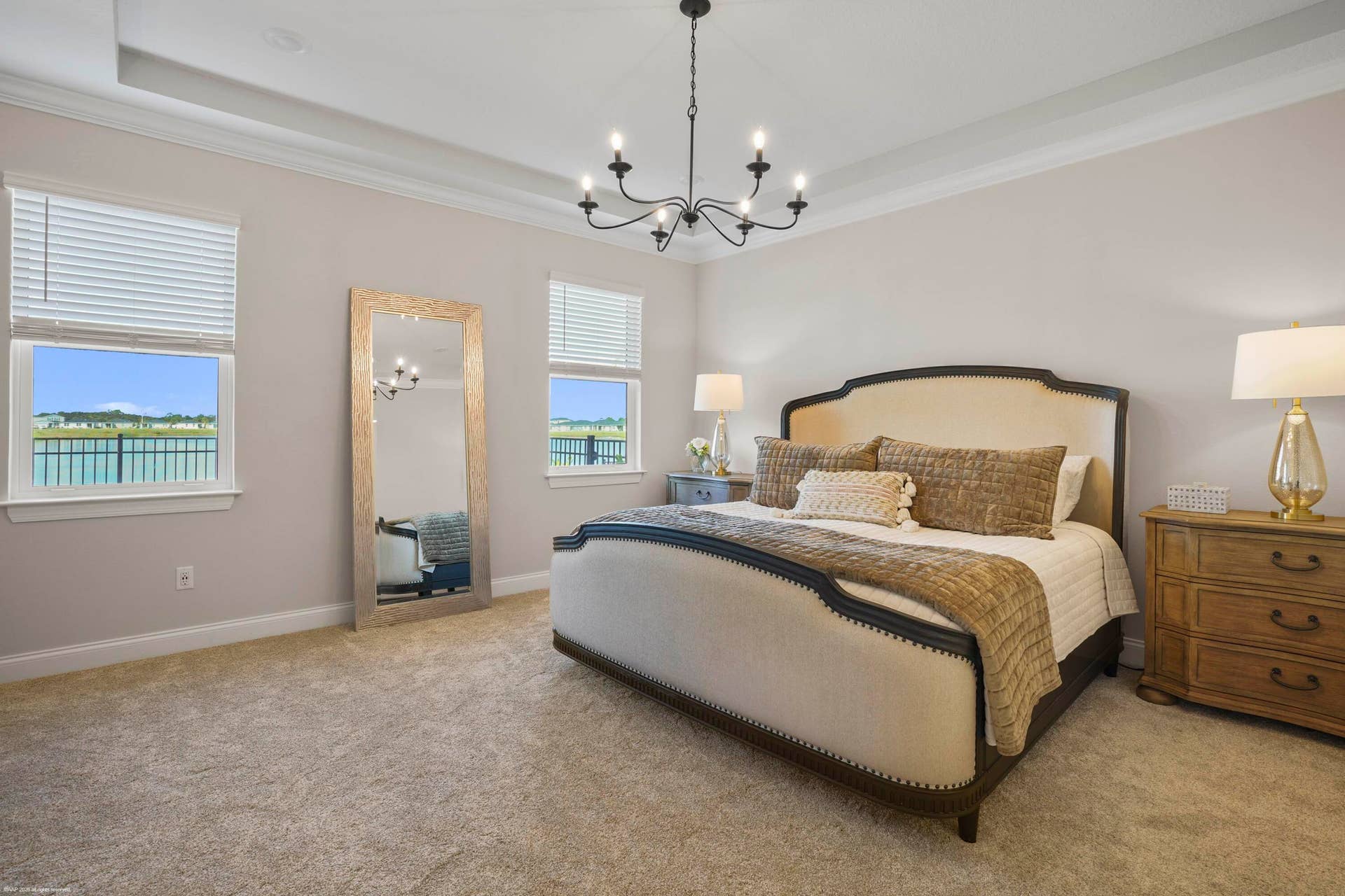 Primary suite with tray ceiling and chandelier