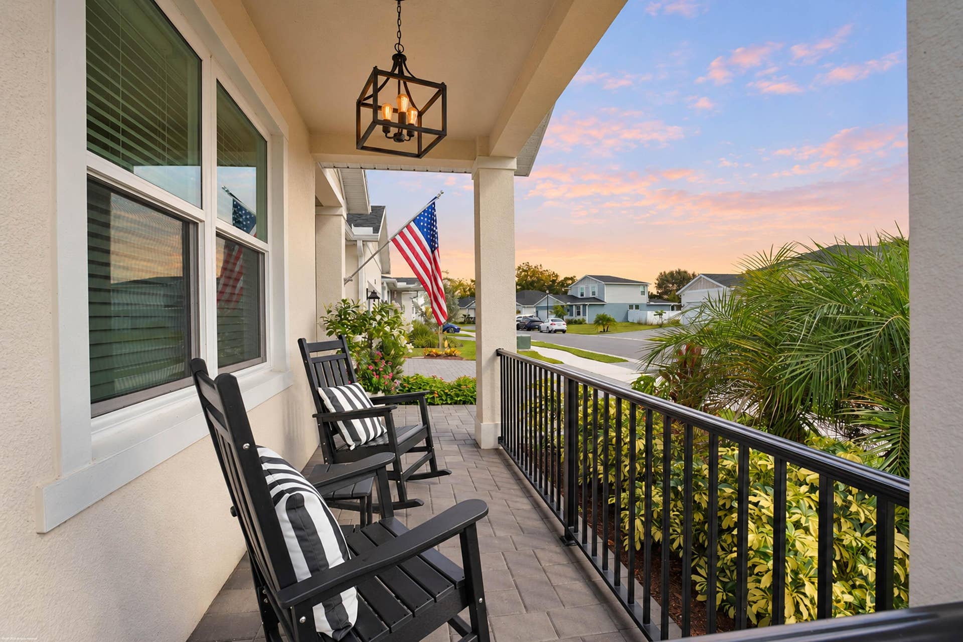 Covered front porch with rocking chairs at sunset