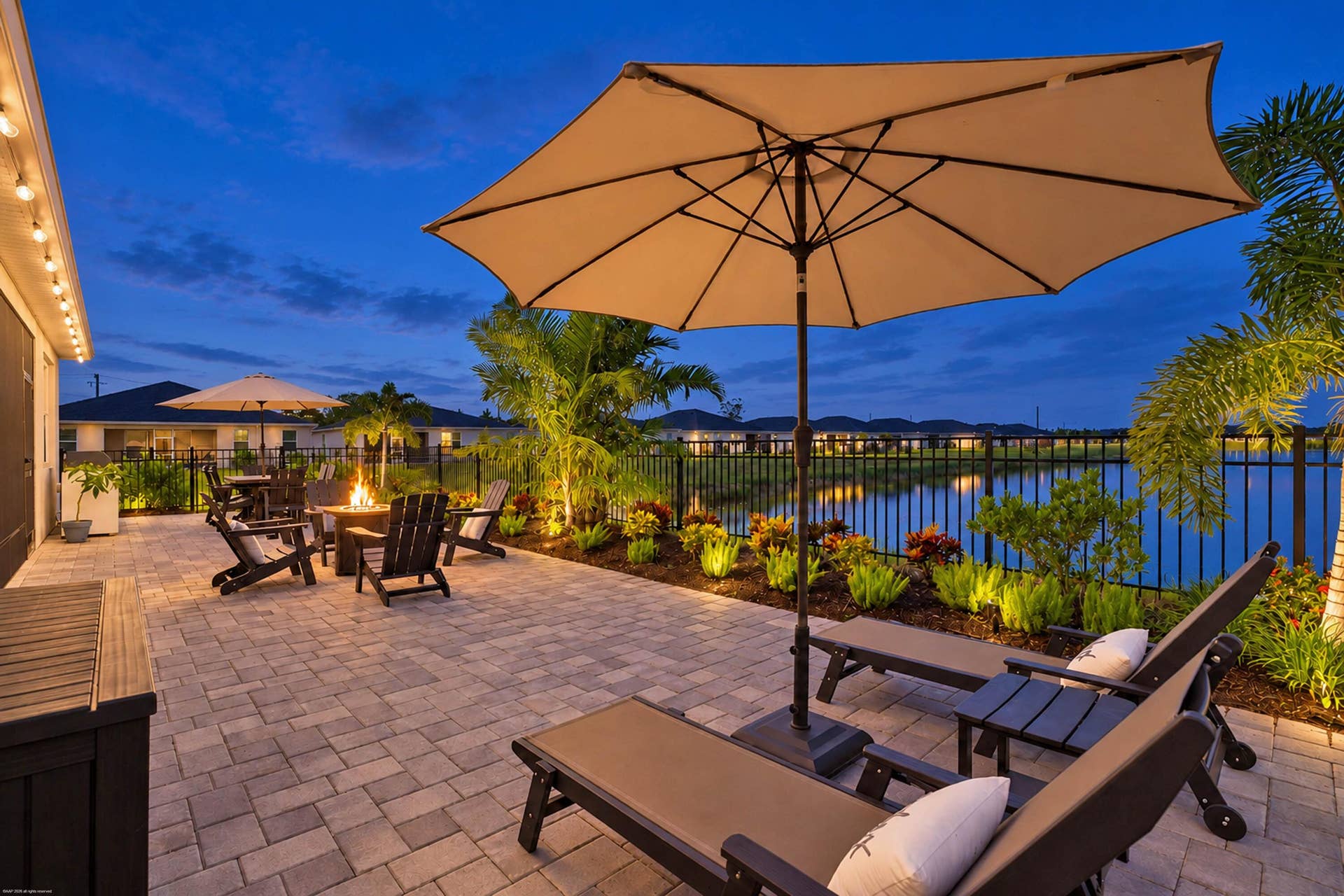Paver patio with lake views at twilight