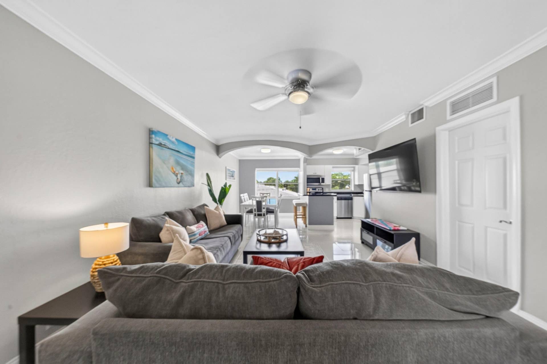 744 NE 14th Avenue, #21, Fort Lauderdale, FL 33304 Recessed lighting, crown molding, and a ceiling fan enhance the living area