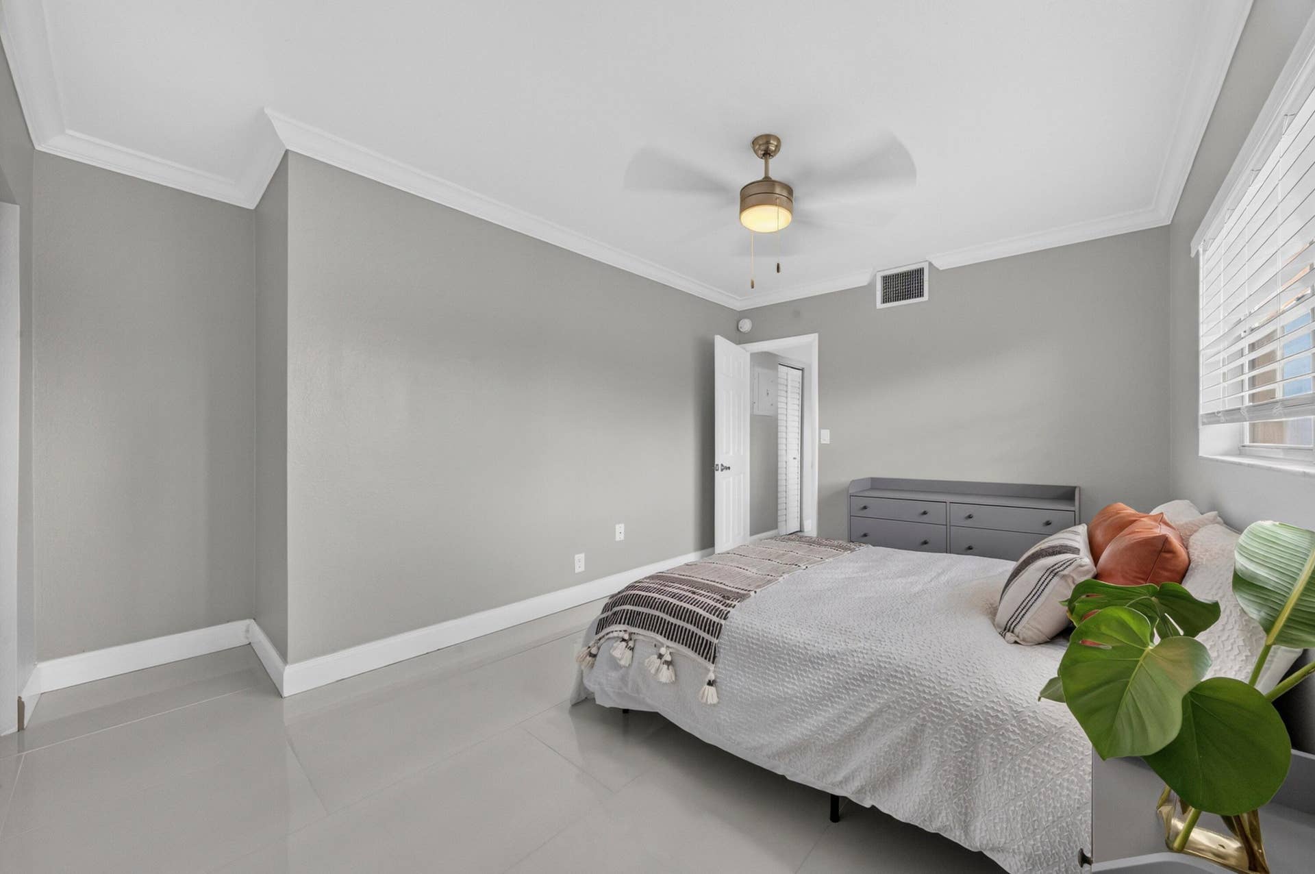 744 NE 14th Avenue, #21, Fort Lauderdale, FL 33304 Recessed lighting, crown molding, ceiling fan, tile flooring, and window with blinds