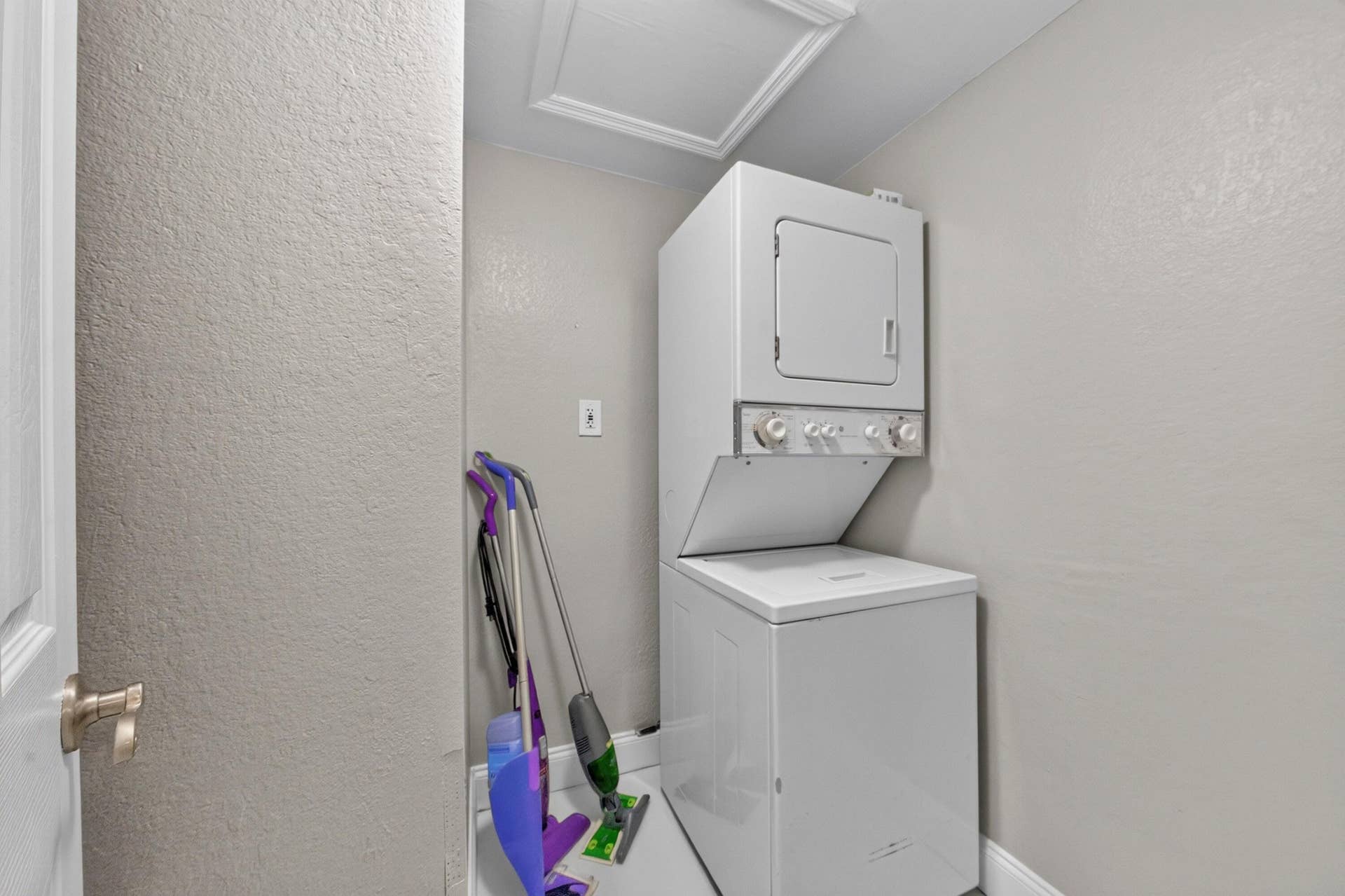 744 NE 14th Avenue, #21, Fort Lauderdale, FL 33304 Compact laundry area with a stacked washer and dryer unit