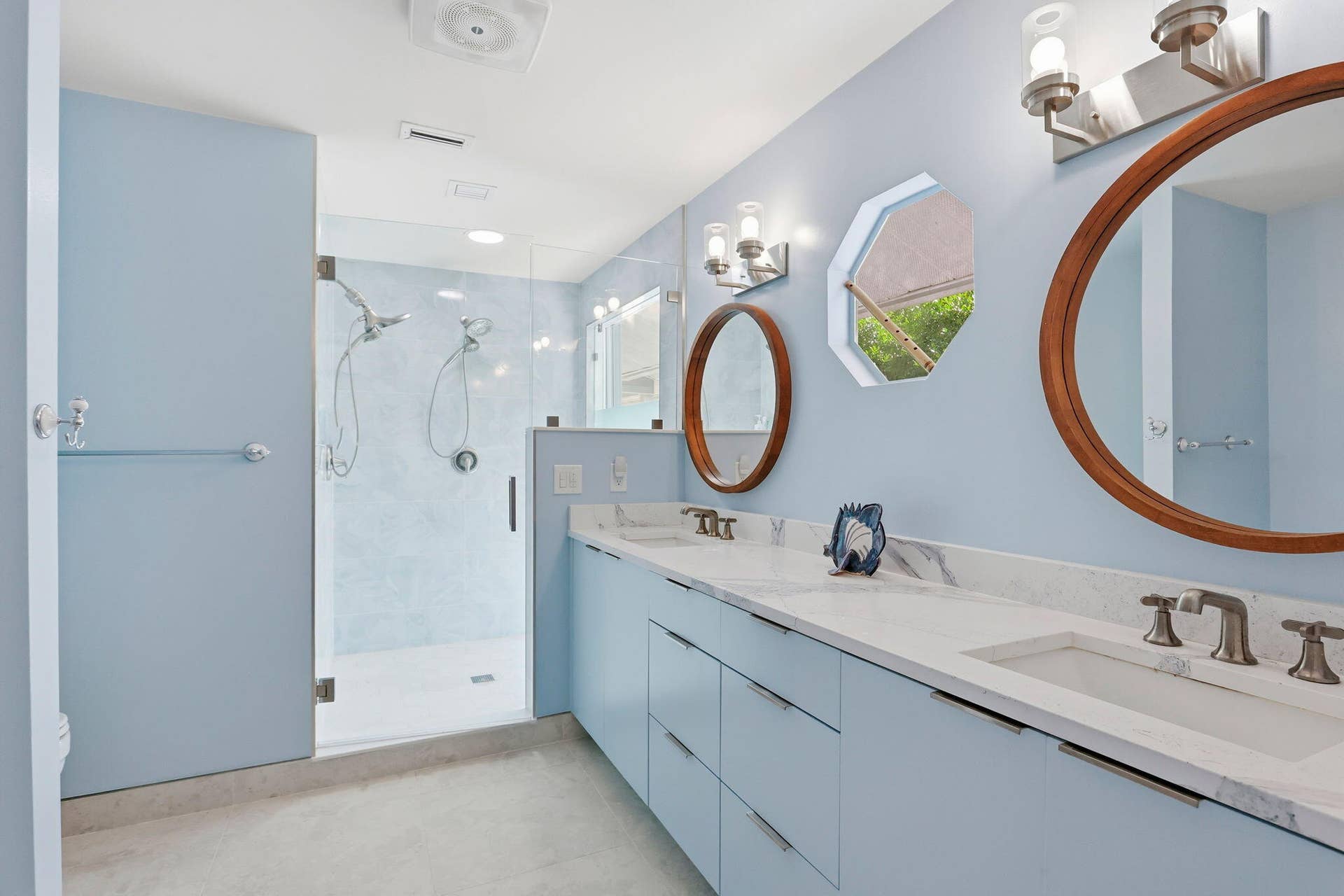 Dual vanity with white undermount sinks and light-toned countertops