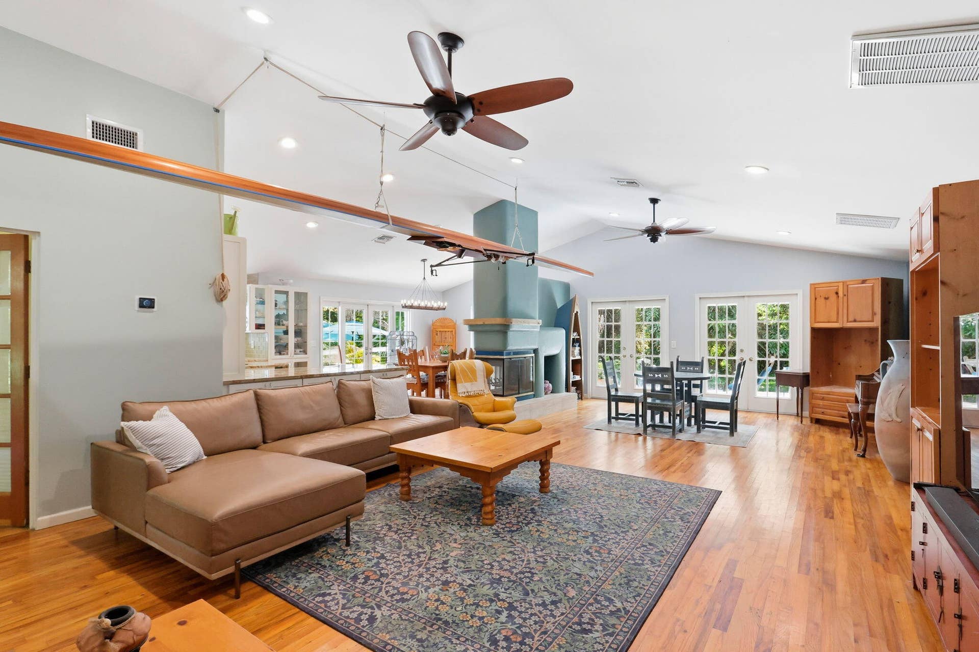 Vaulted ceiling, recessed lighting, oak wood flooring, and a 3 sided wood burning fireplace