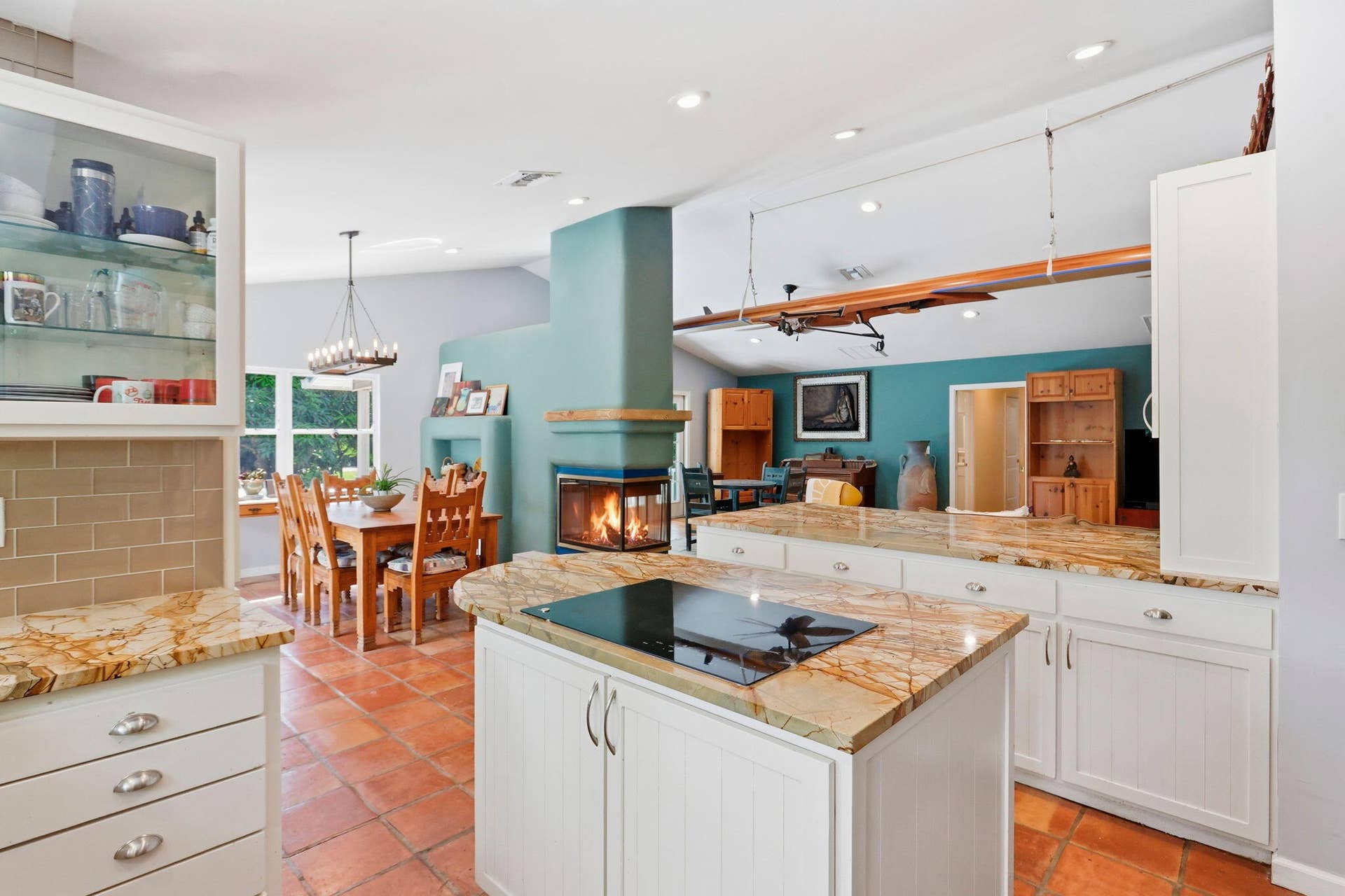 Kitchen opens to the living room, the fireplace, and the dining room