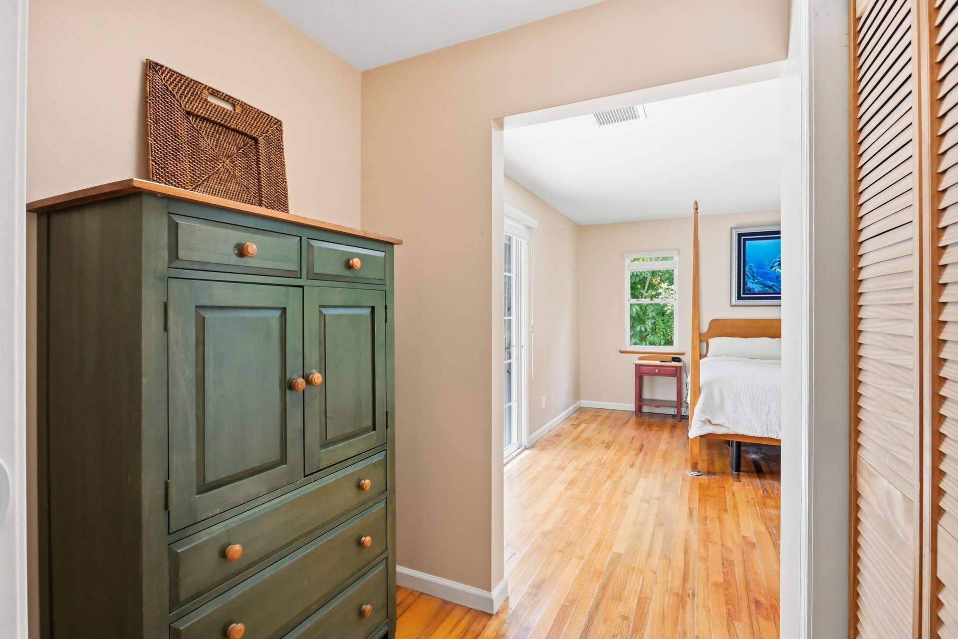 Hardwood-style flooring extends through the room, complemented by neutral wall tones