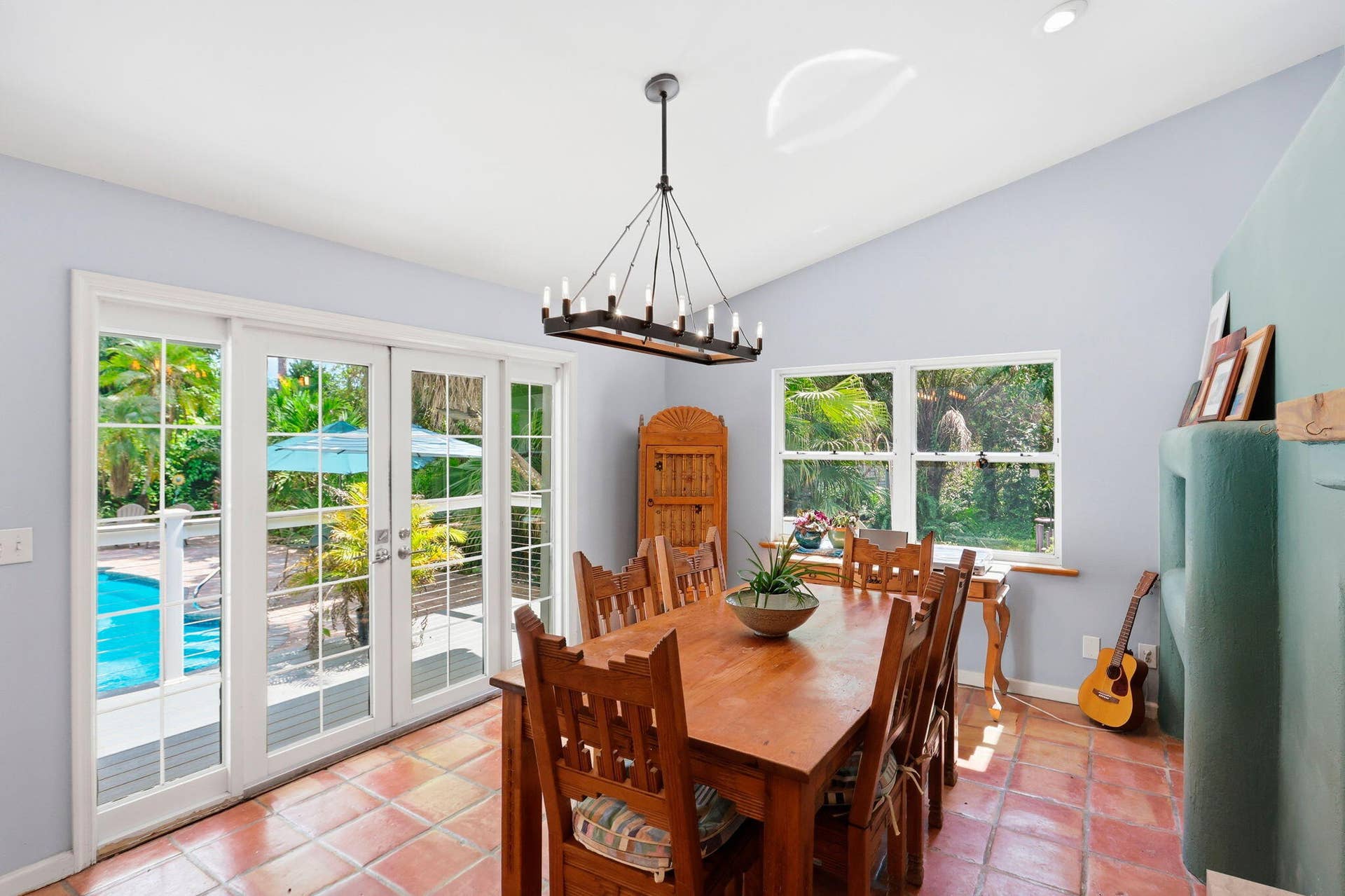 Terracotta tile flooring, vaulted ceiling, and recessed lighting