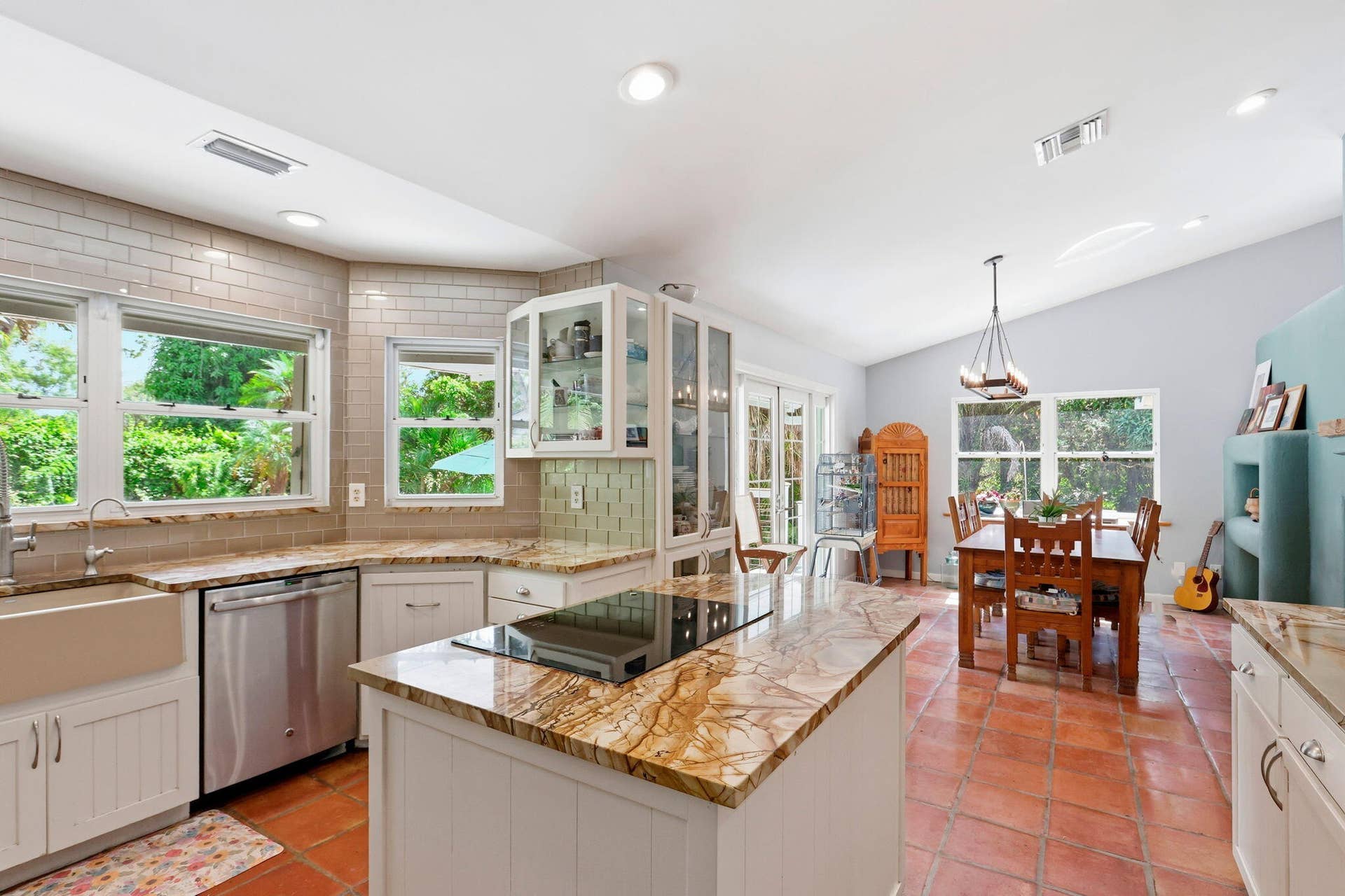 With bay windows that overlook the pool and connect to the dining room