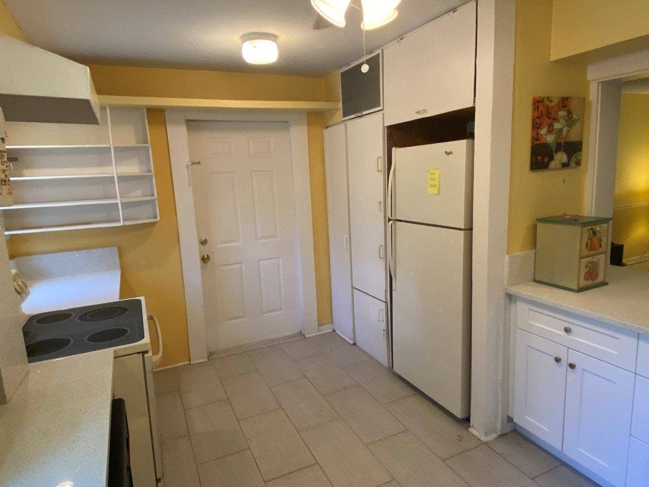 Kitchen with Refrigerator and Door to Laundry & Utility Storage Room