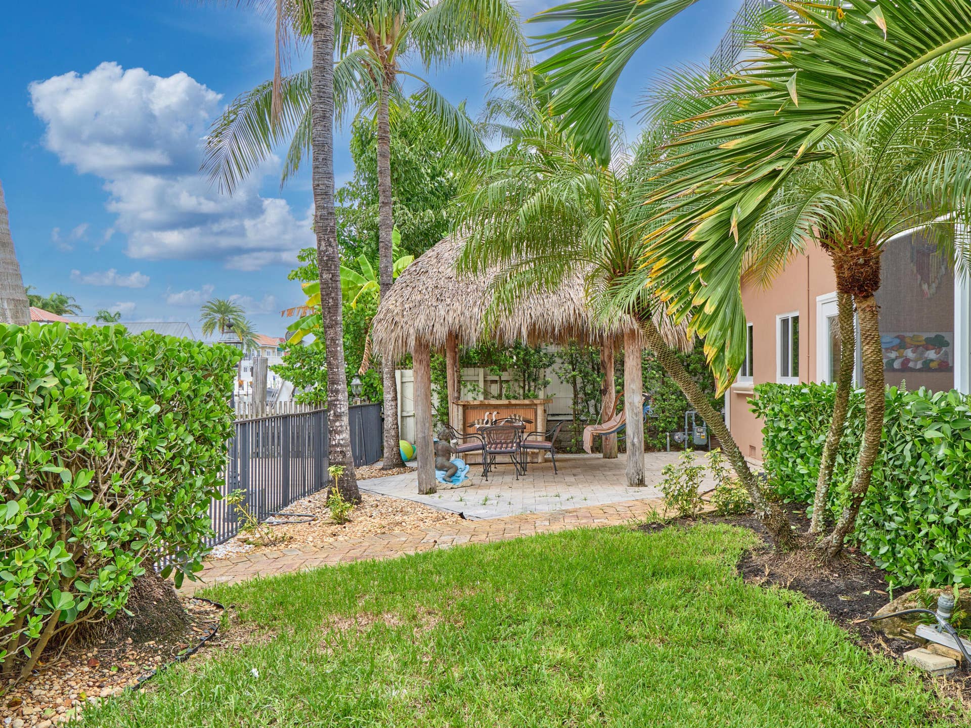 Tropical backyard with Tiki hut