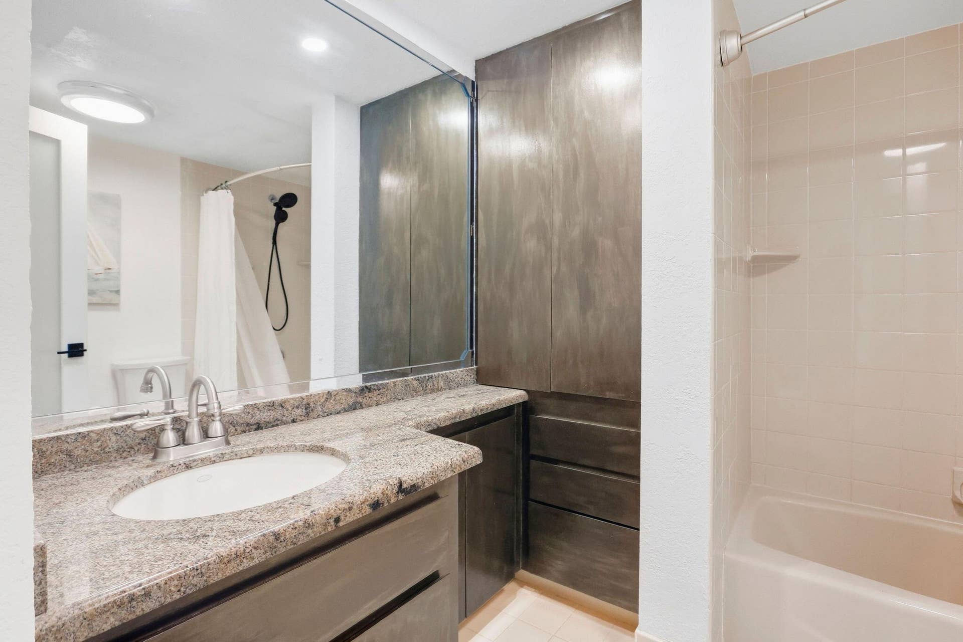 900 Greensward Lane, #209-G, Delray Beach, FL 33445 Vanity with a granite-style countertop, undermount sink, and dual-handle faucet