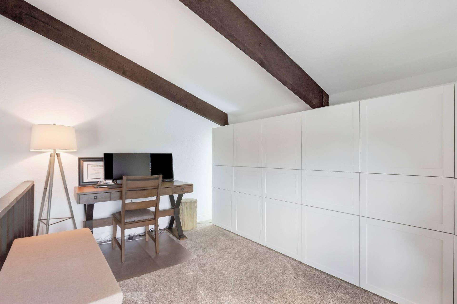 900 Greensward Lane, #209-G, Delray Beach, FL 33445 Sloped ceiling with exposed wood beams, built-in white cabinetry, and carpeted flooring