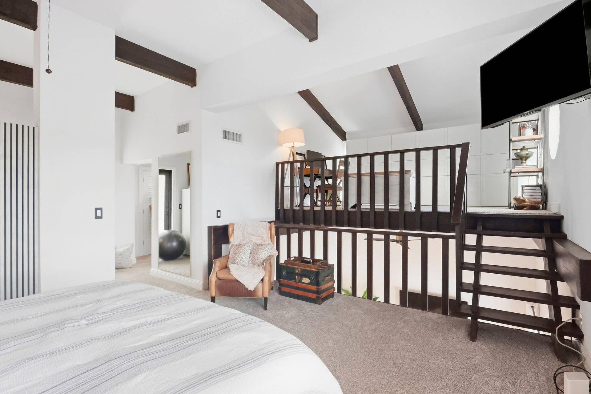 900 Greensward Lane, #209-G, Delray Beach, FL 33445 Vaulted ceilings with exposed beams, built-in shelving, and a multi-level layout with an integrated staircase