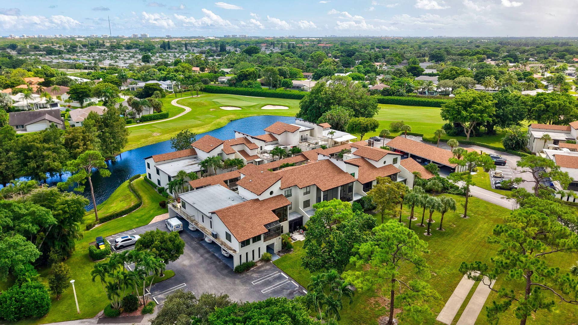 900 Greensward Lane, #209-G, Delray Beach, FL 33445 Multiple residential structures featuring white exteriors and terracotta-style roofing