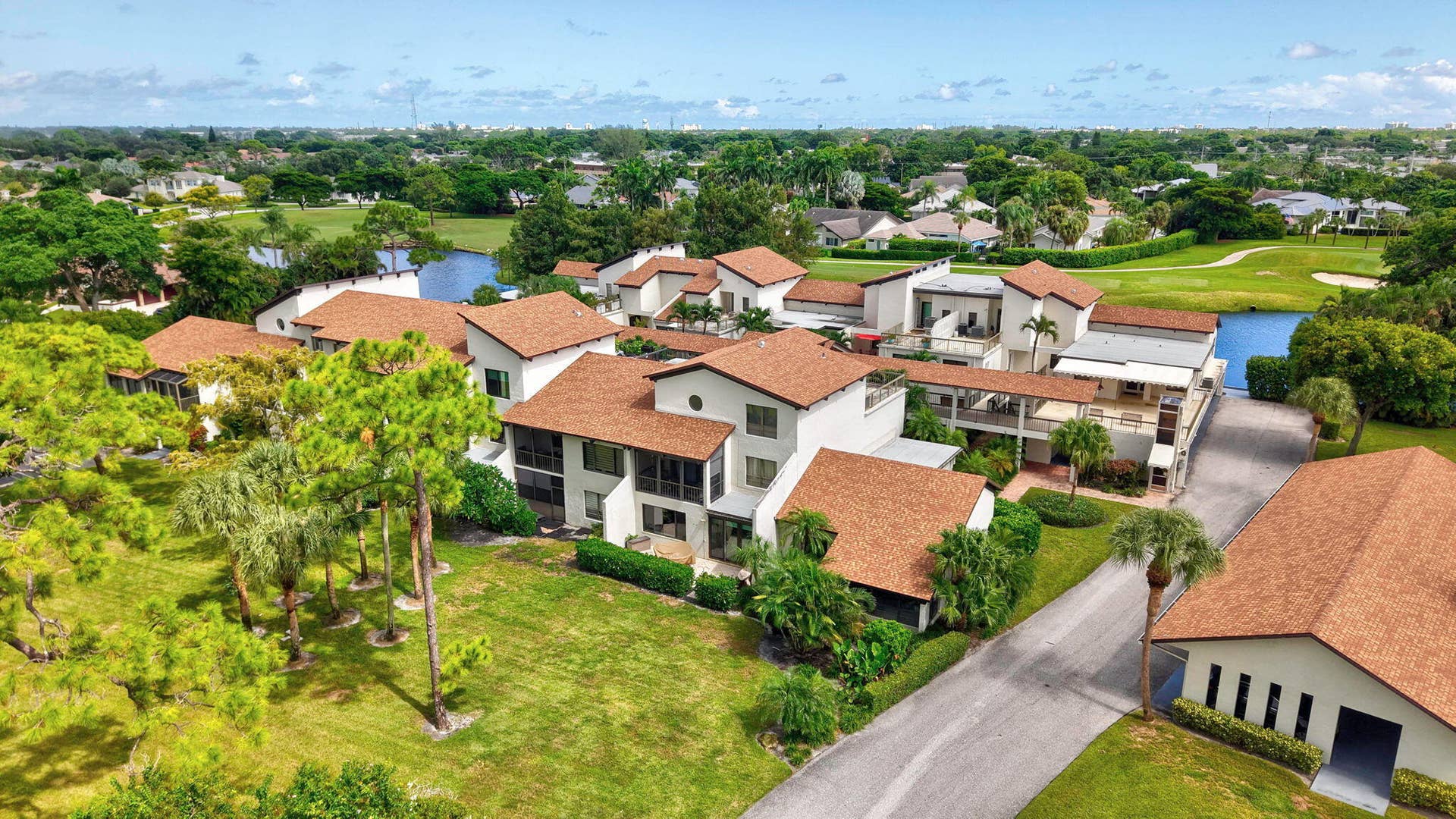 900 Greensward Lane, #209-G, Delray Beach, FL 33445 Multiple structures with terracotta-style roof tiles and white stucco exteriors
