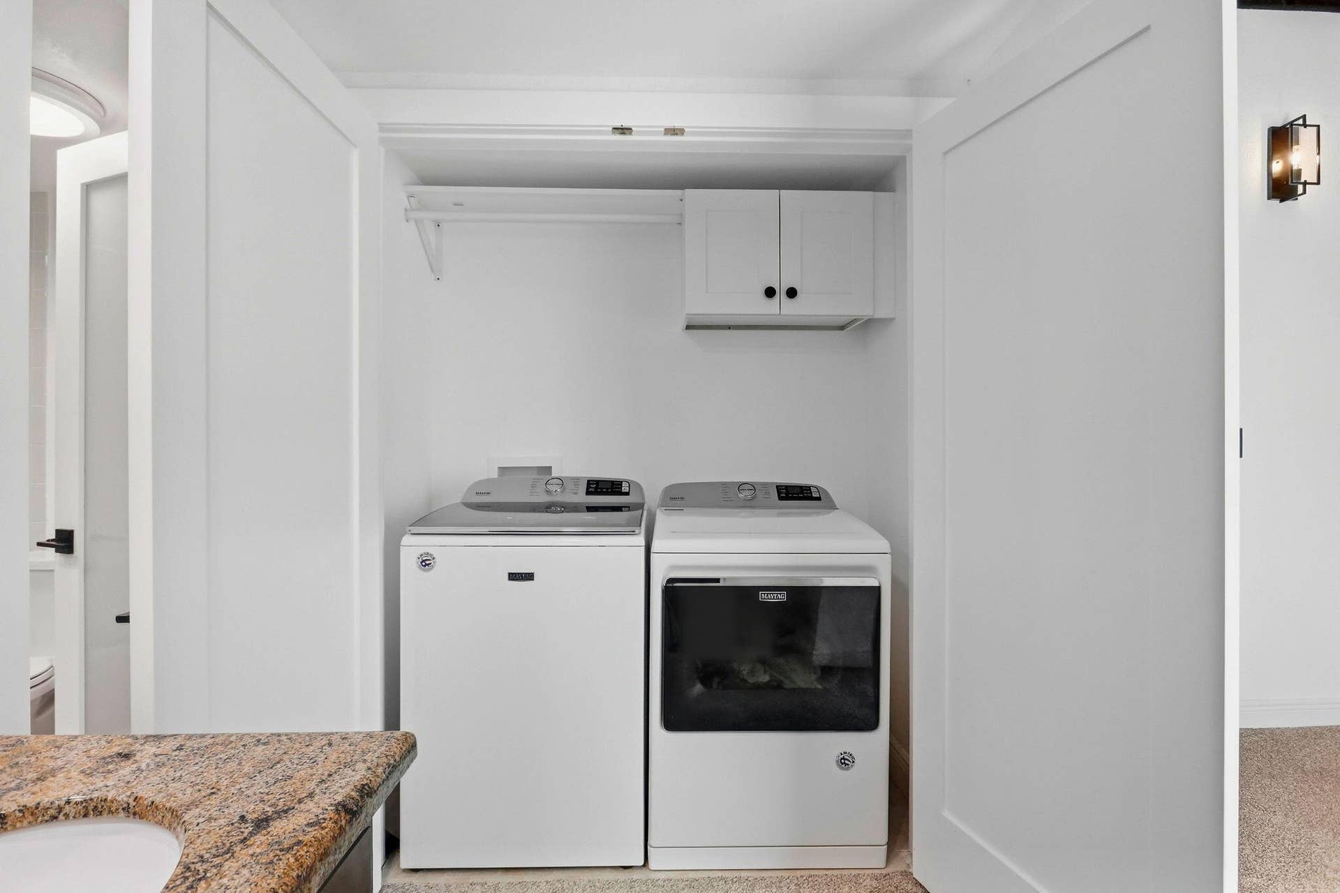 900 Greensward Lane, #209-G, Delray Beach, FL 33445 Dedicated laundry closet featuring a built-in shelf, storage cabinet, and white bi-fold doors